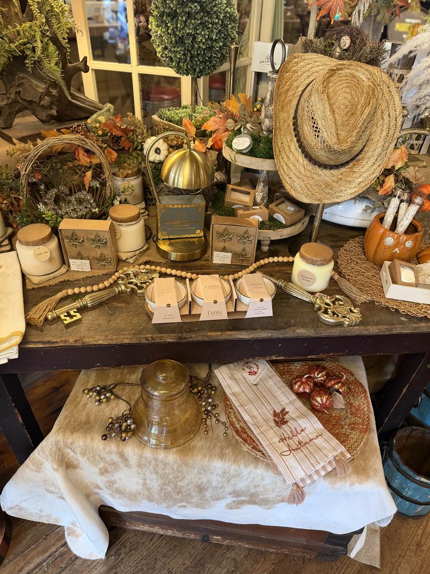Autumn candles, gold leaf pumpkins and a straw hat on the seasonal table at Horse Feathers Mercantile