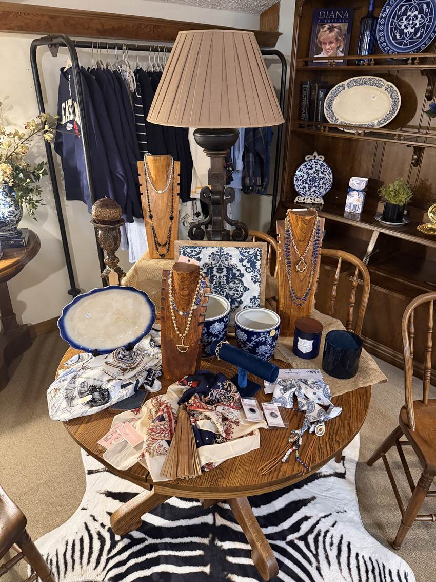 Blue and white china, scarves and pearls arranged on an oak table at Horse Feathers Mercantile