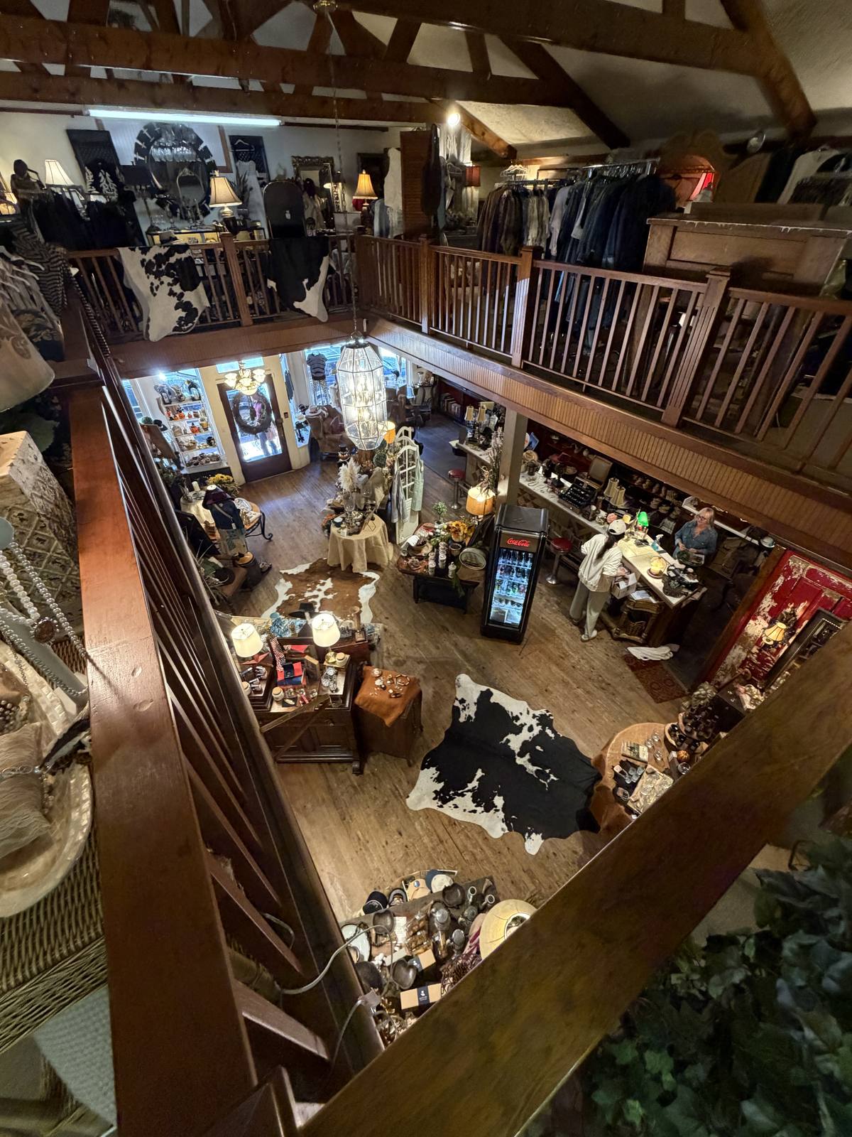 View from the balcony over two floors of clothing, rugs and antiques inside Horse Feathers Mercantile in Dillsboro North Carolina