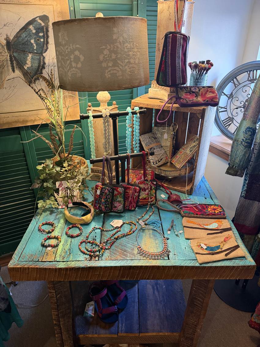 Turquoise and beaded necklaces on a painted plank table at Horse Feathers Mercantile
