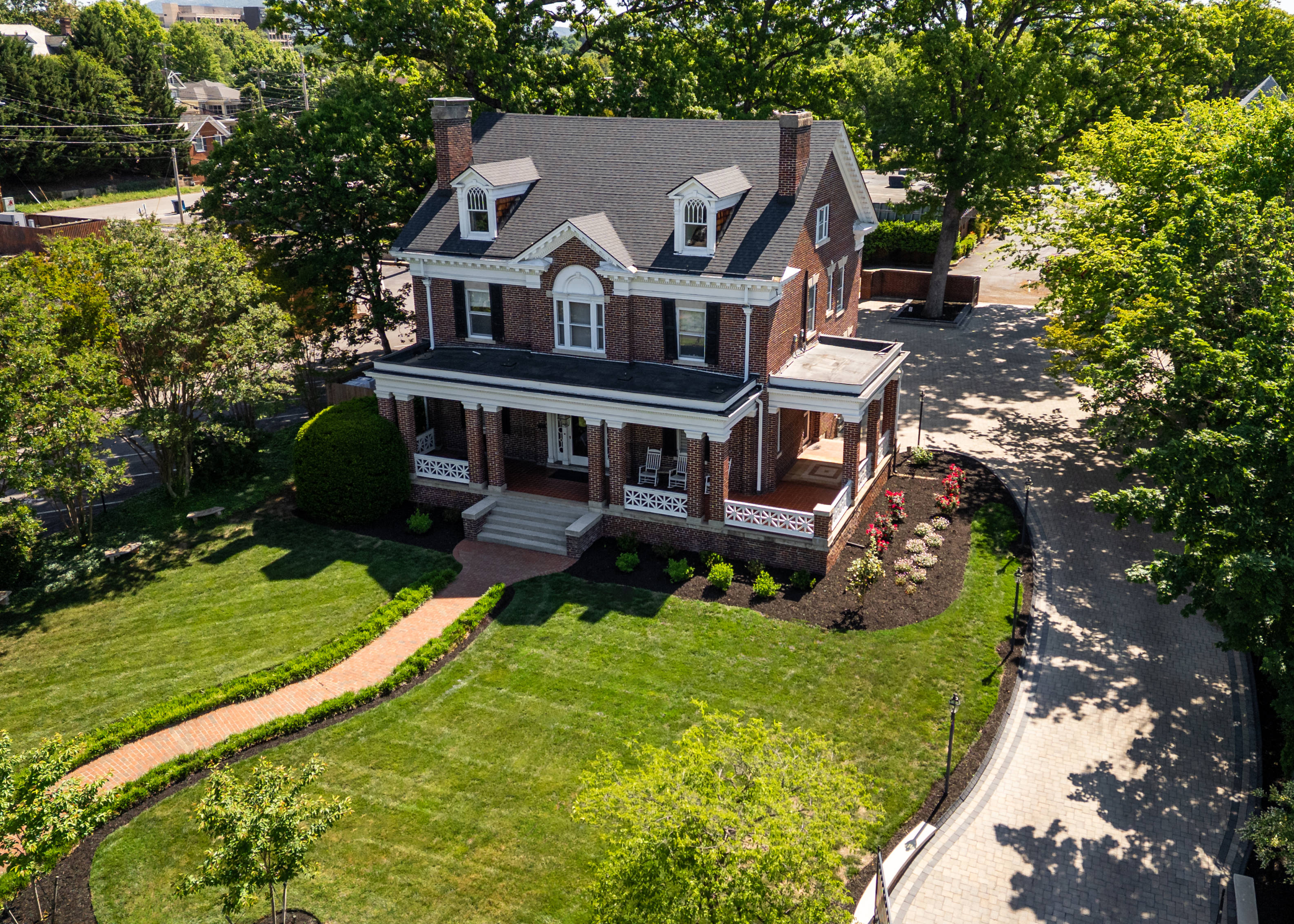 Historic Bent Oaks Manor in Roanoke with lawn and wraparound porch