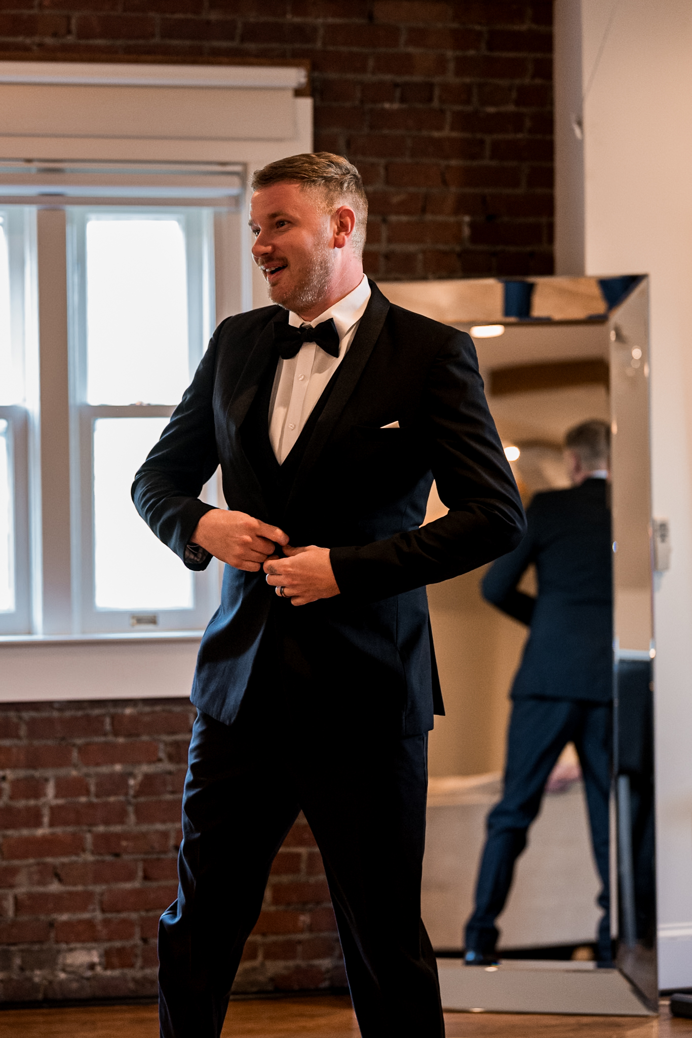 groom getting ready in loft prep space