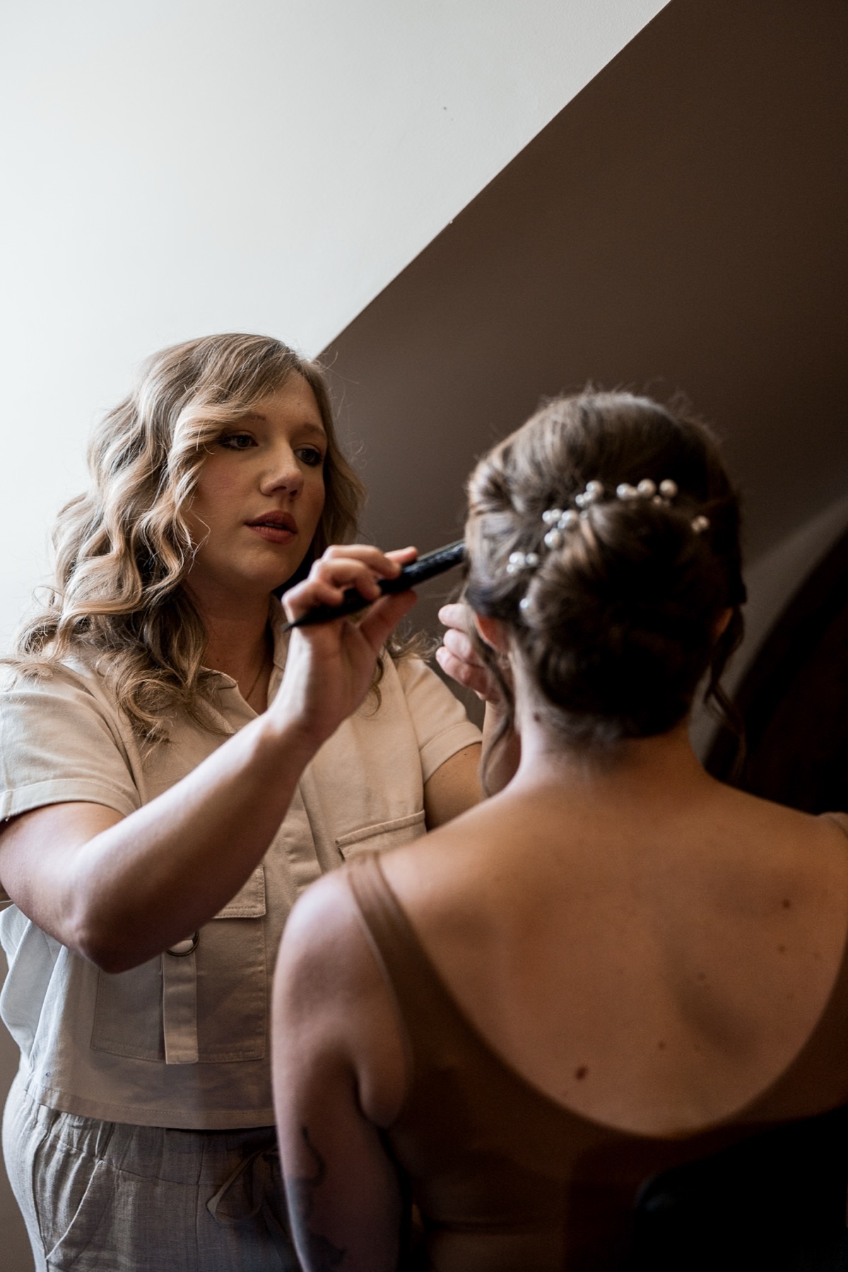 Hair and makeup preparation in a getting-ready room at Bent Oaks Manor.