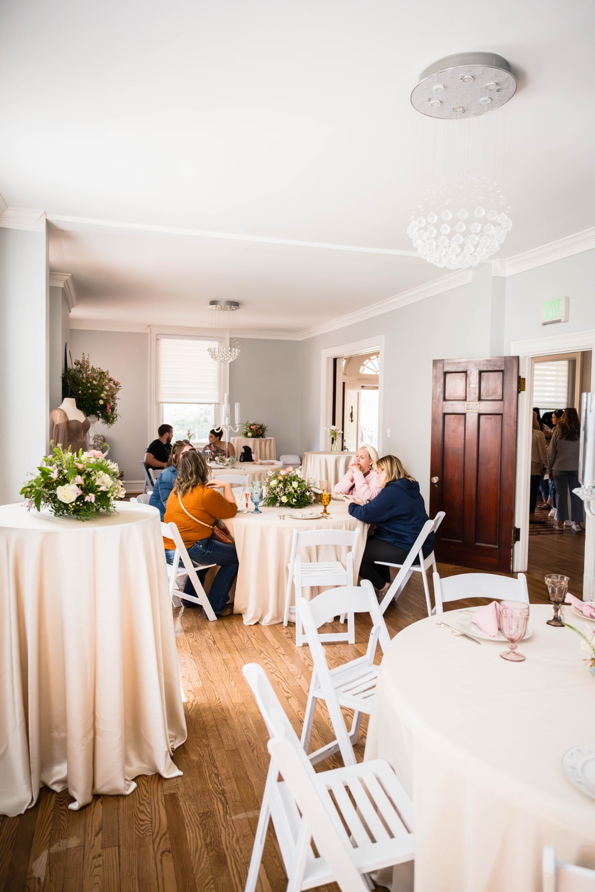 Indoor reception room with round tables and white chairs at Bent Oaks Manor in Roanoke.