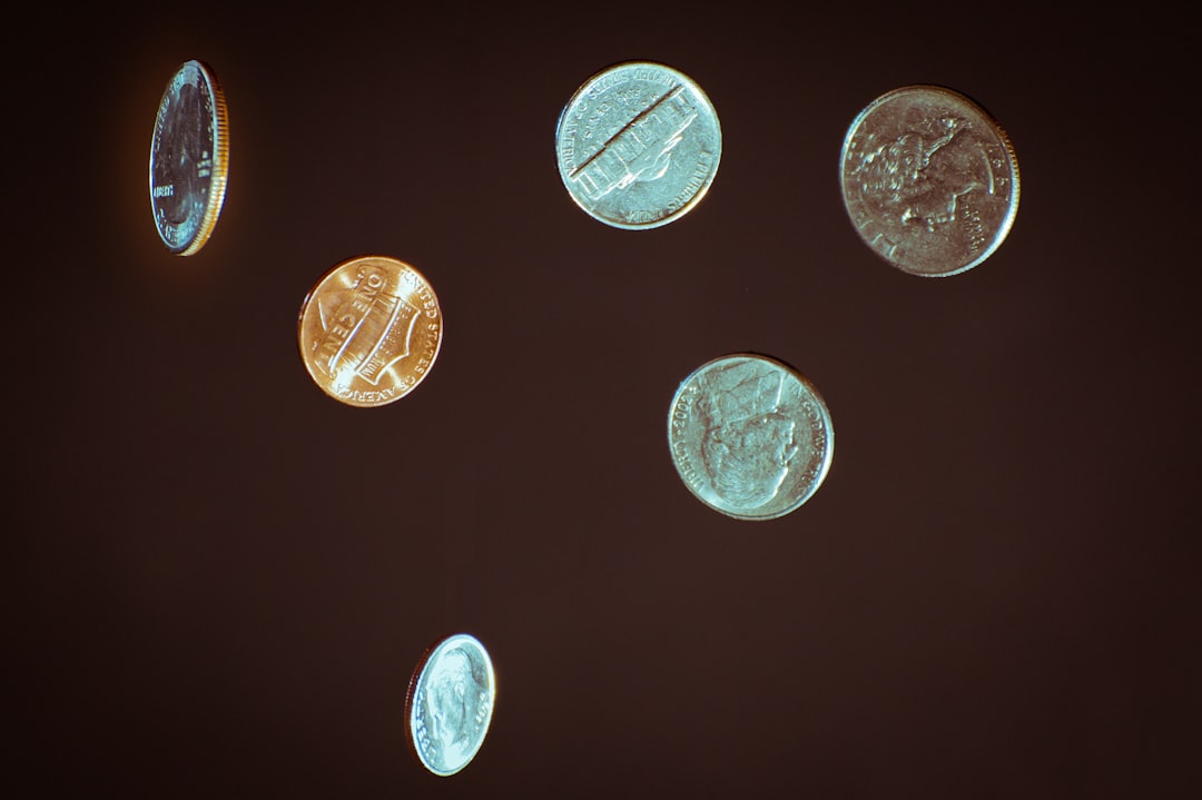 Six United States coins photographed against a dark brown background with soft rim lighting.
