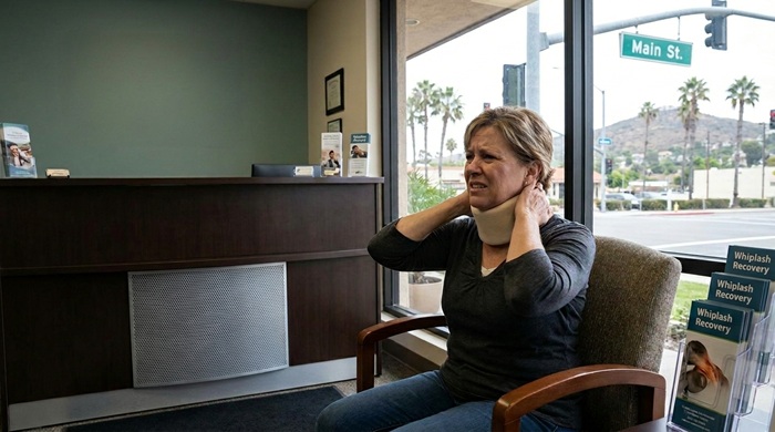 Person experiencing neck pain from whiplash injury in El Cajon CA