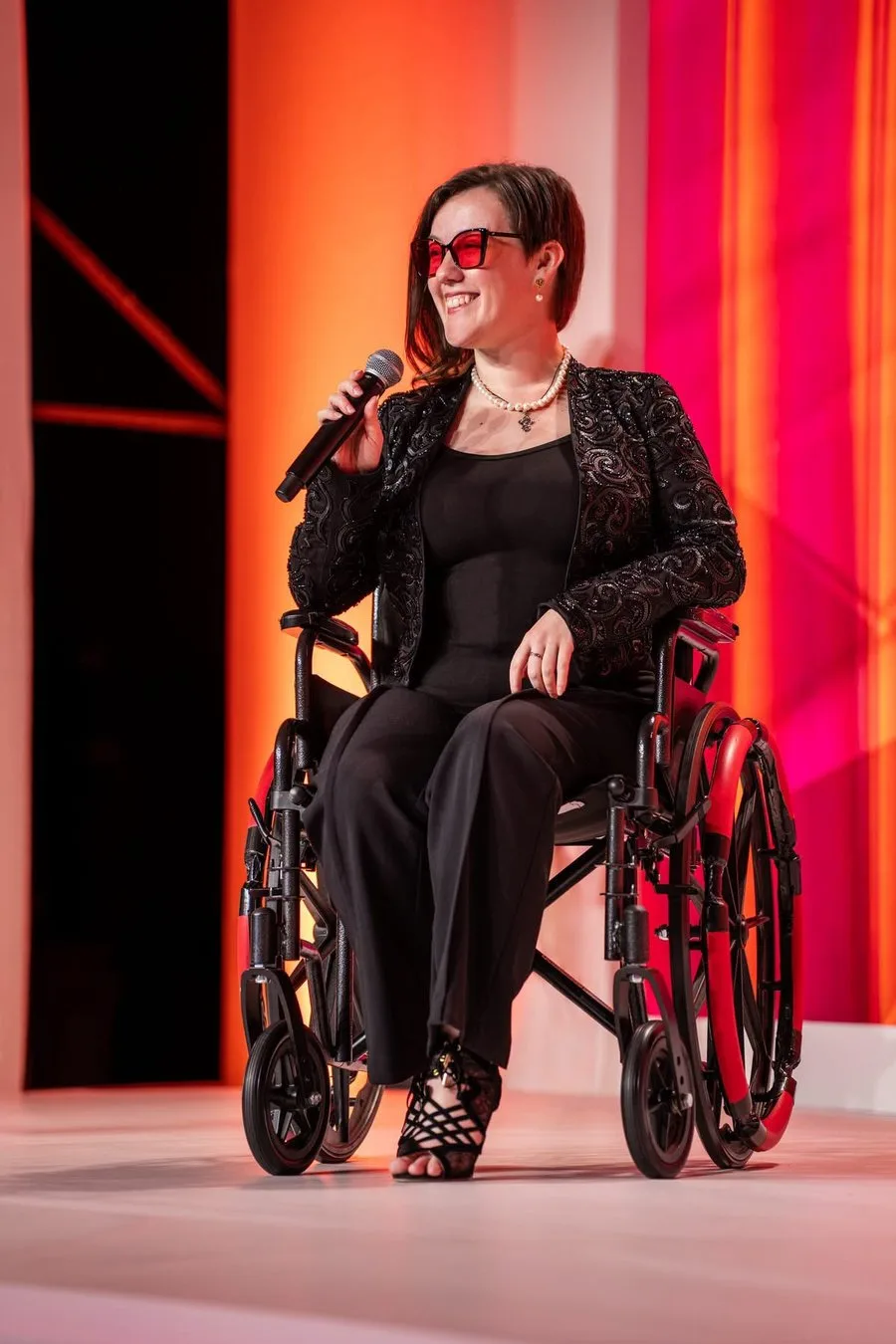 Masha Pavlova speaking on stage at a gala event