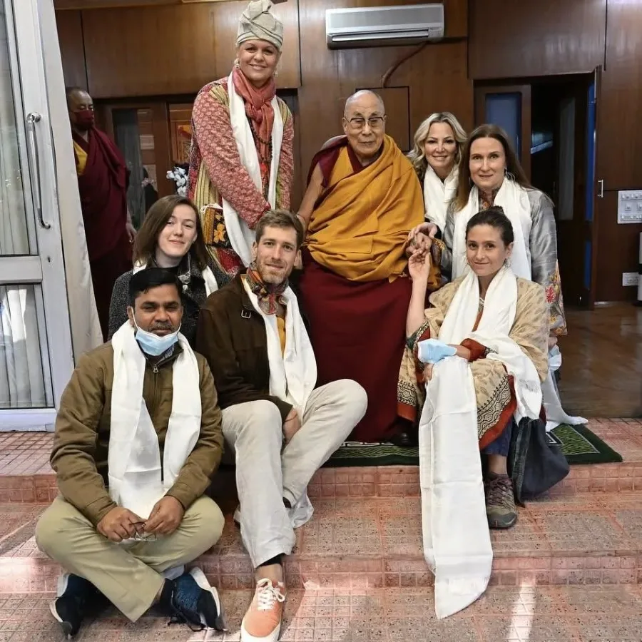 Masha Pavlova holding hands with His Holiness the Dalai Lama in India