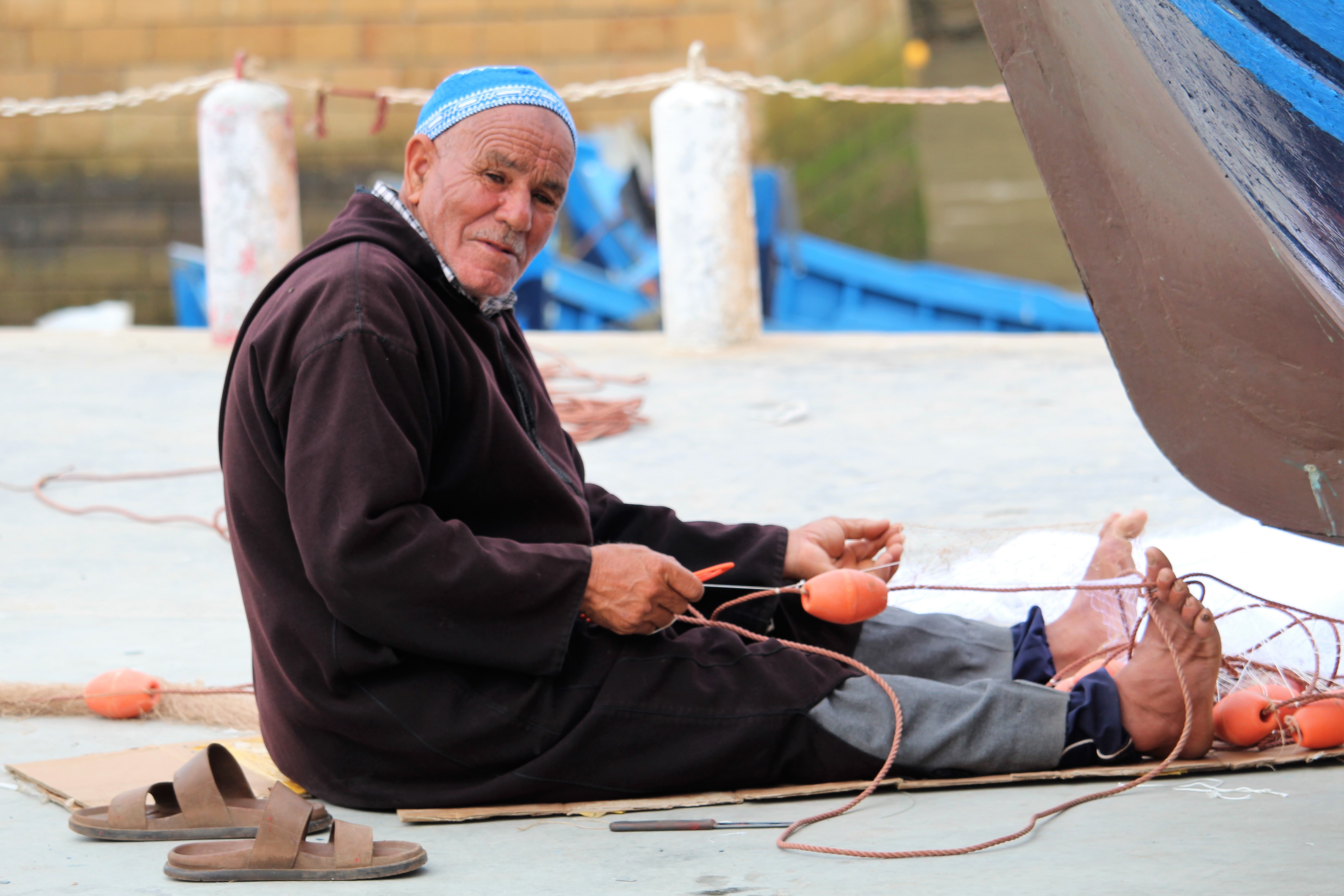 Fisherman mending his net