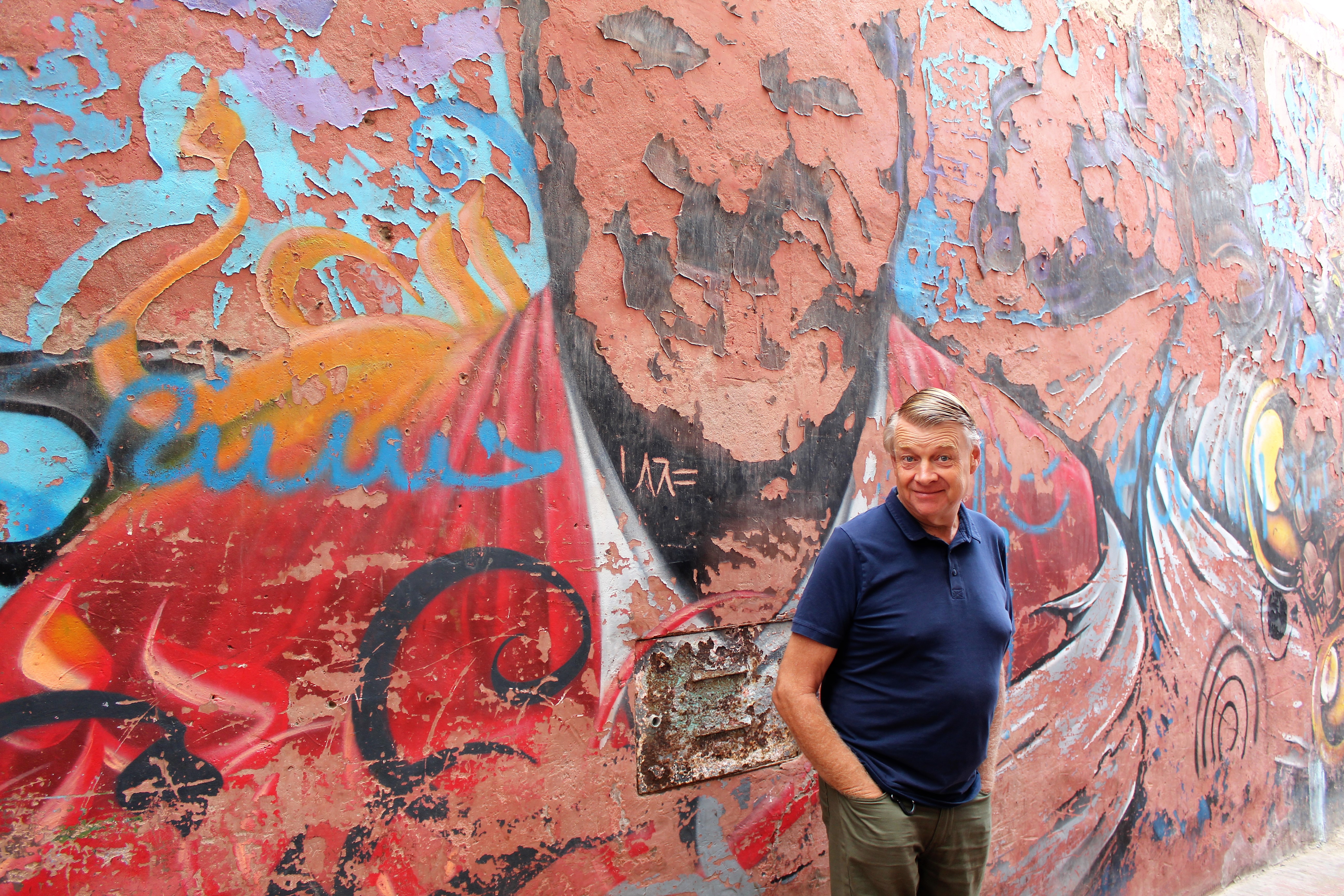 Mark in front of some faded street art in Essaouira