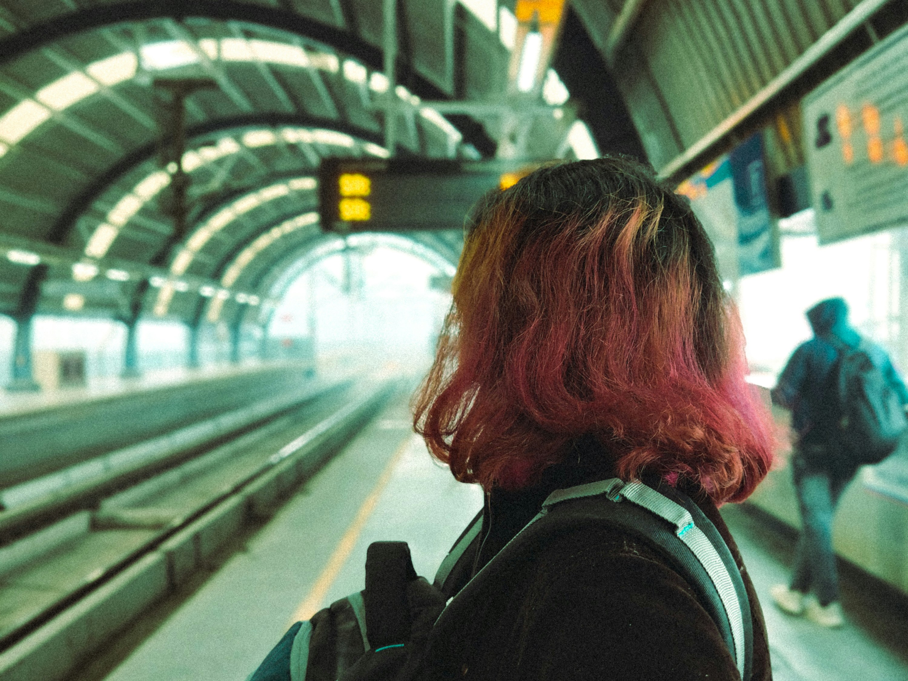 Woman on a platform at a train station
