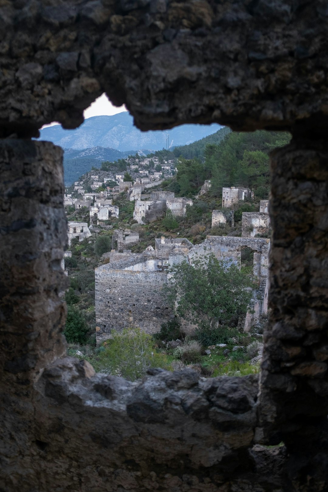 Kayakoy through the window of an adandoned church Kayakoy through the window of an adandoned church