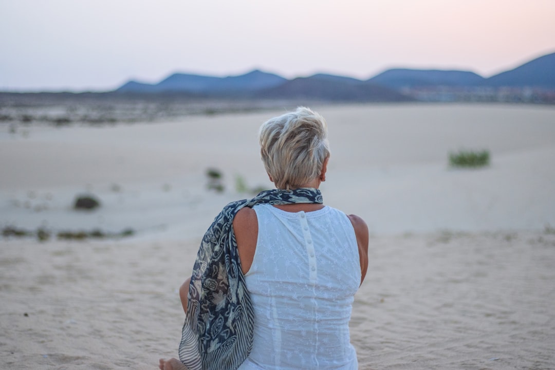 Older woman sitting on a beach