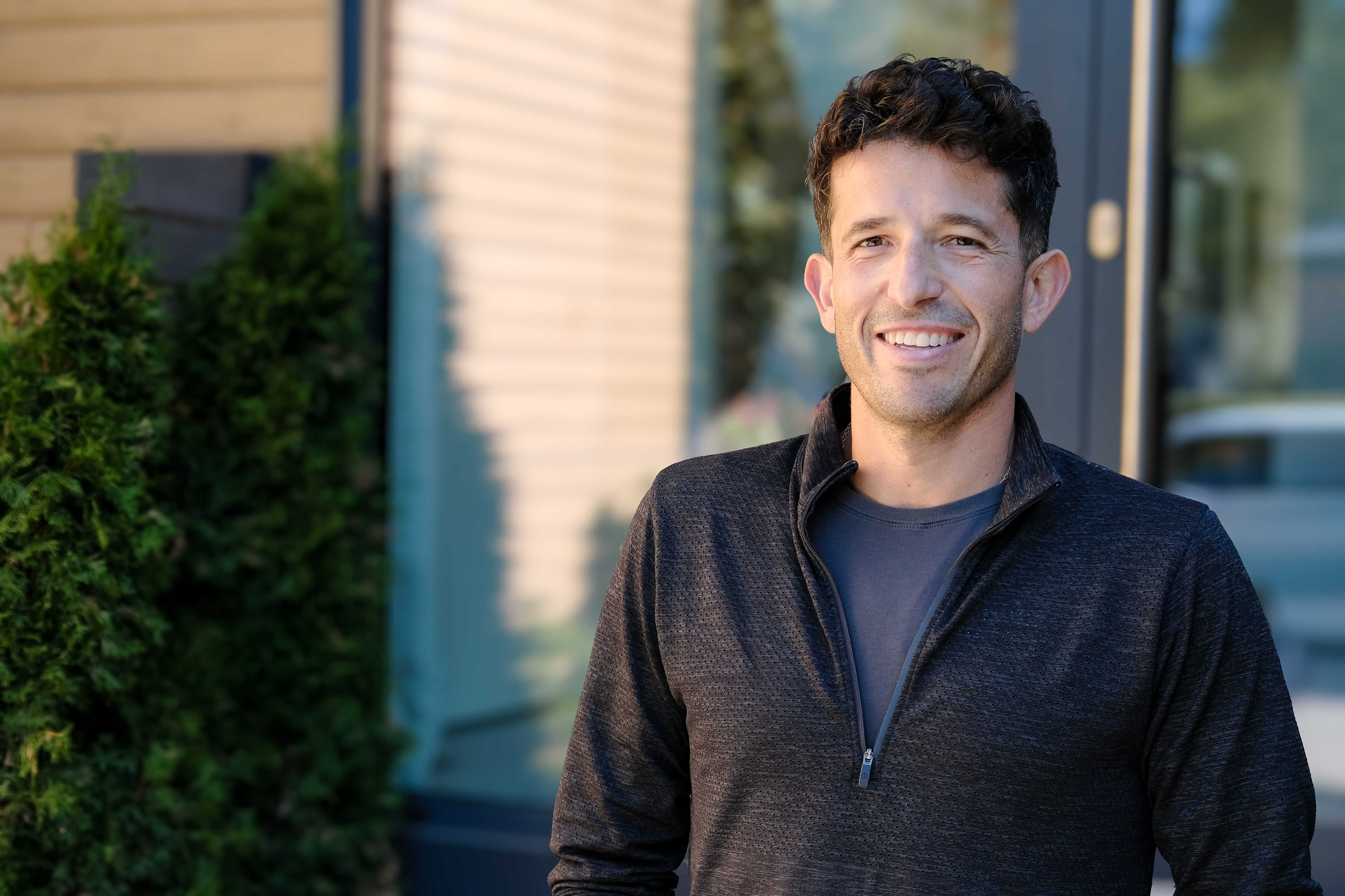 Mark Berman of M Berman Homes stands outside a house.