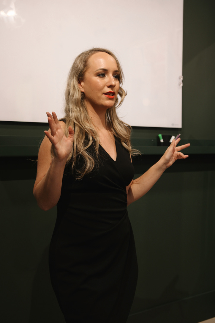 Speaker delivering a powerful talk on the Women with Impact Summit stage