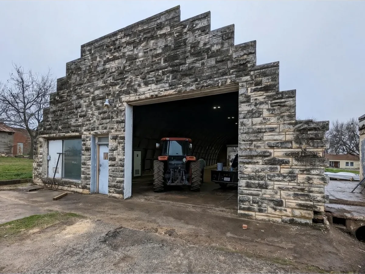 Stone building before cleaning, dark staining on the stone