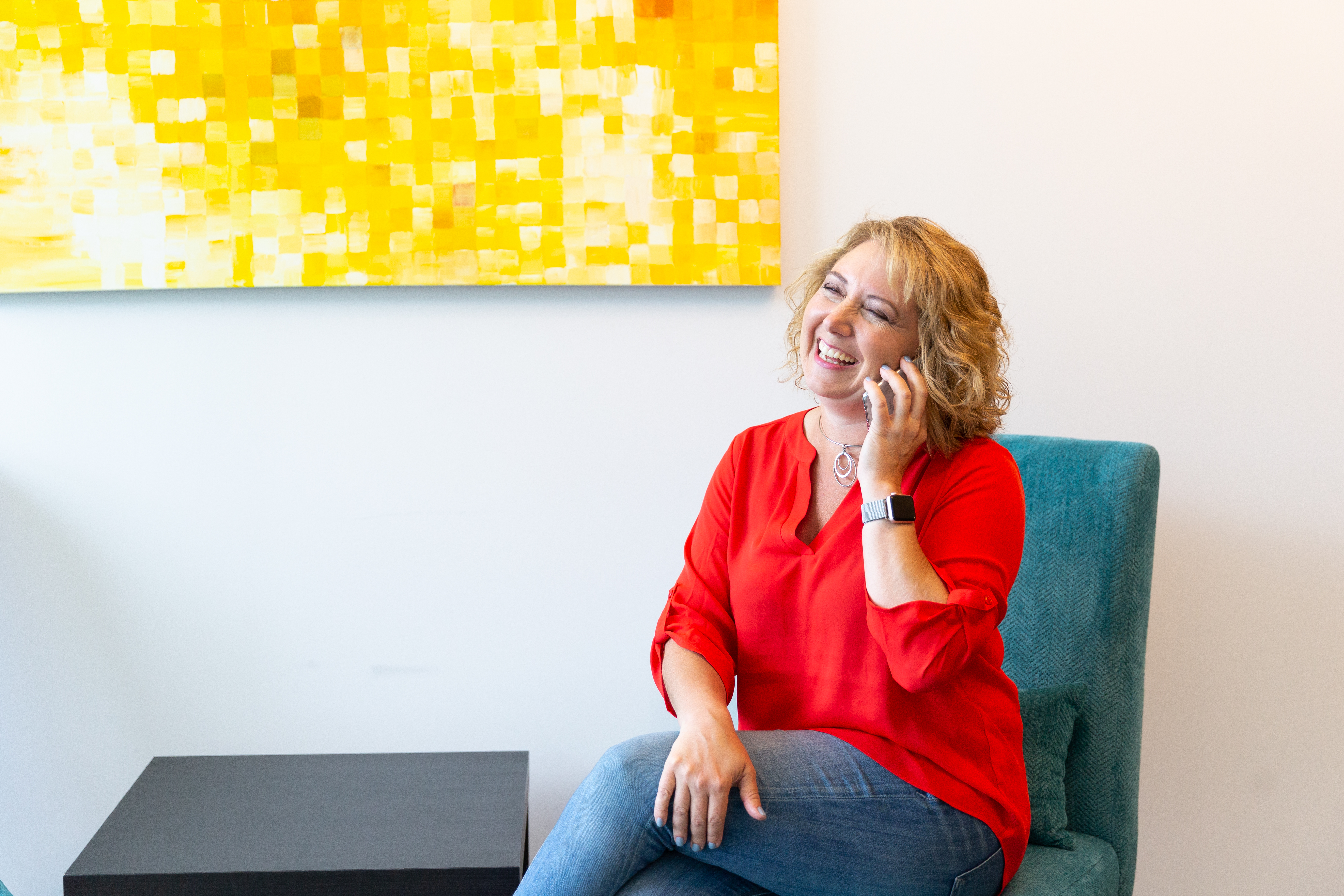 Kristen Arnold, Fractional COO and leadership strategist, smiling while talking with a client about business operations and team leadership.