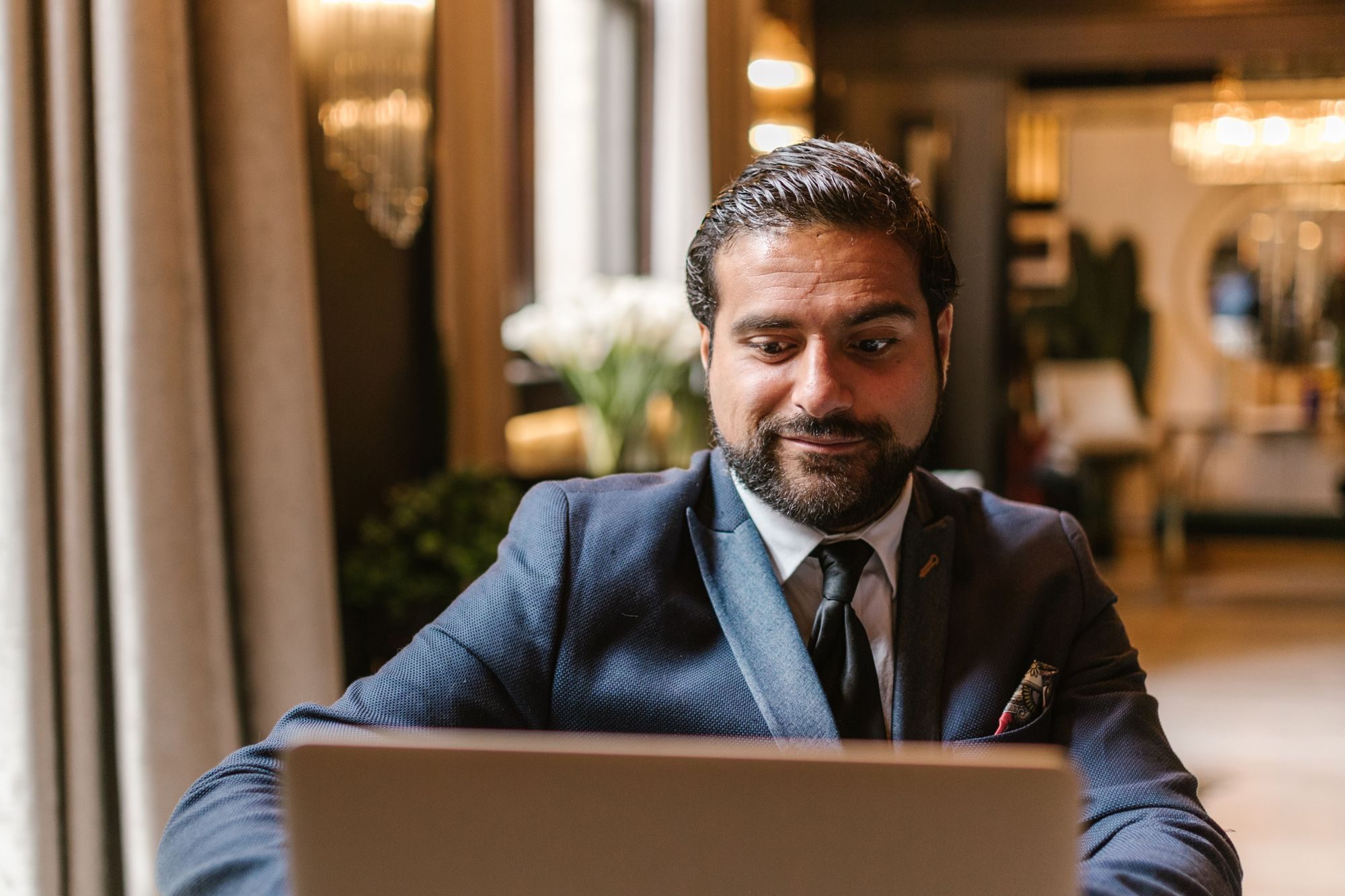 A business owner working through next steps on his laptop