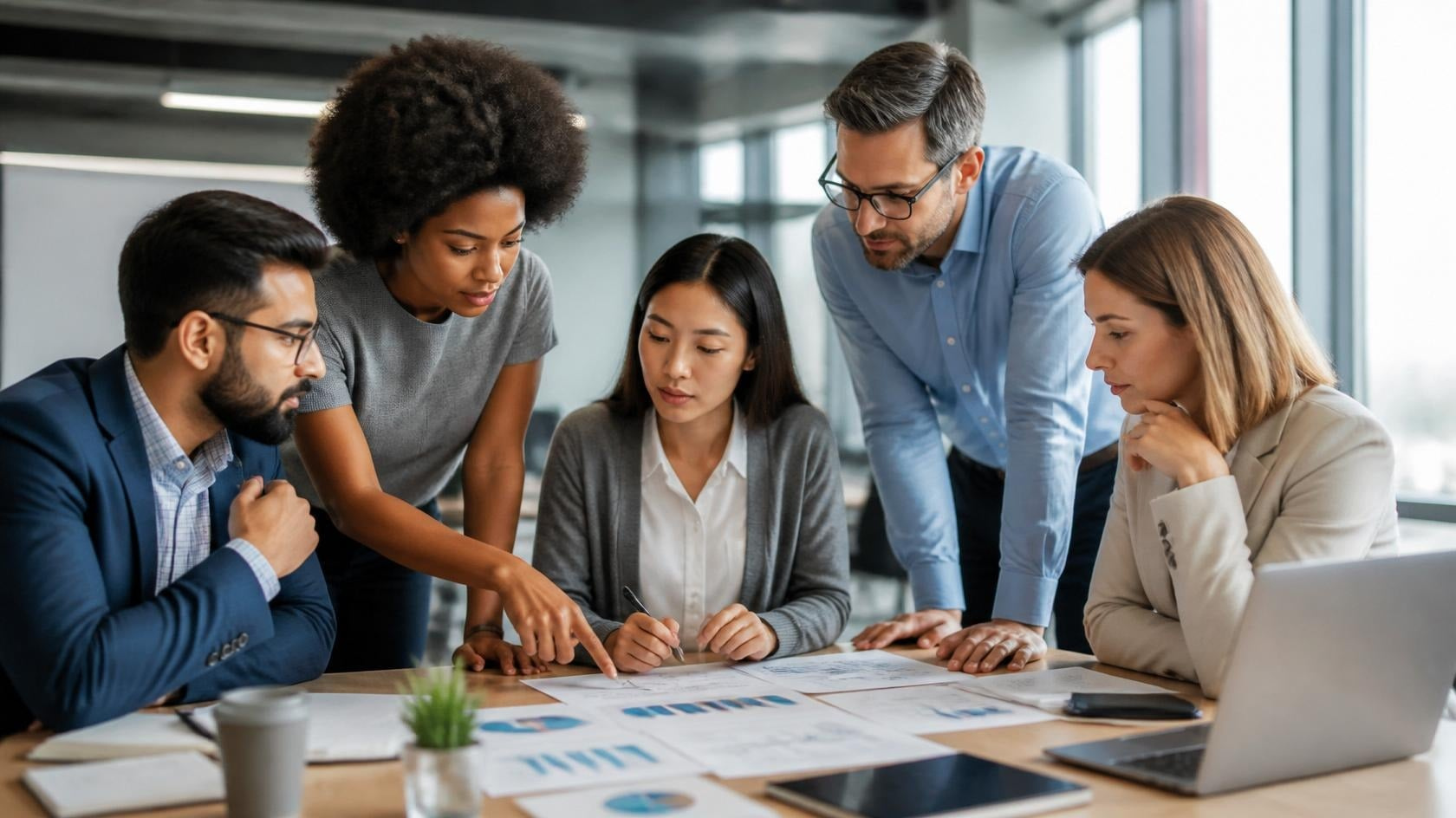 Diverse team analyzing procurement planning data and long-term strategic alignment Diverse team analyzing procurement planning data and long-term strategic alignment