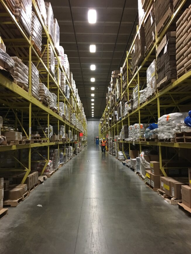 a warehouse with persony shelves