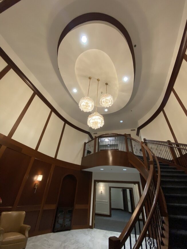 a staircase with a chandelier