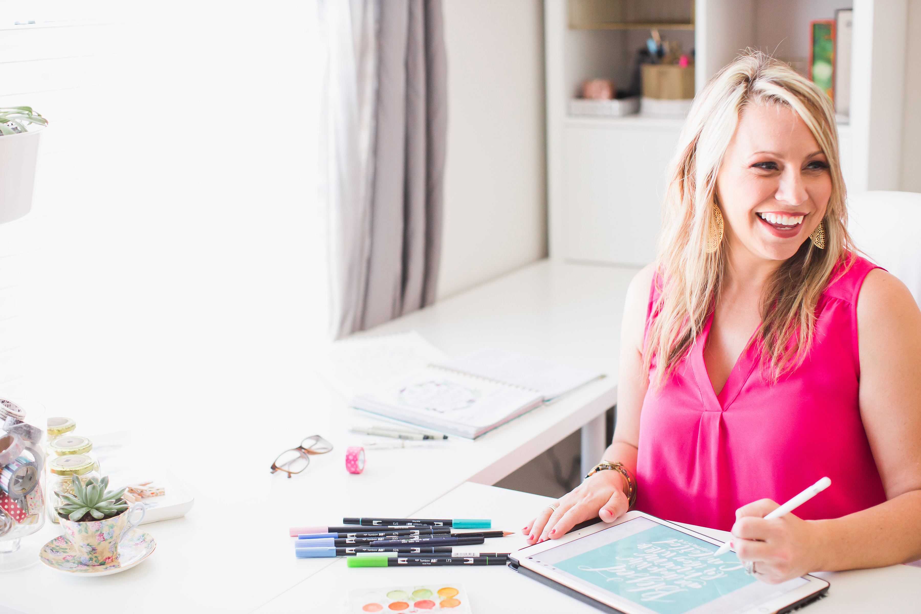 Krystal Whitten hand lettering at her desk
