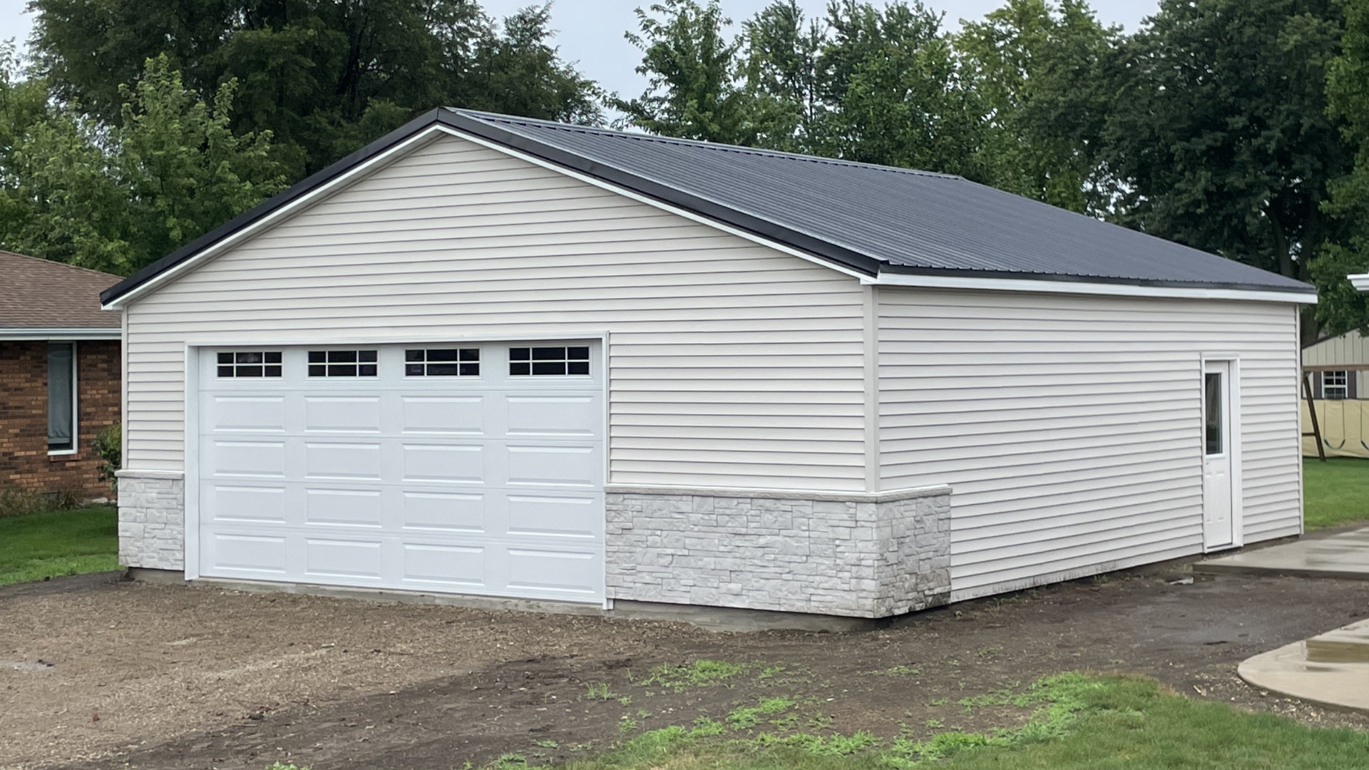 Detached garage with white siding