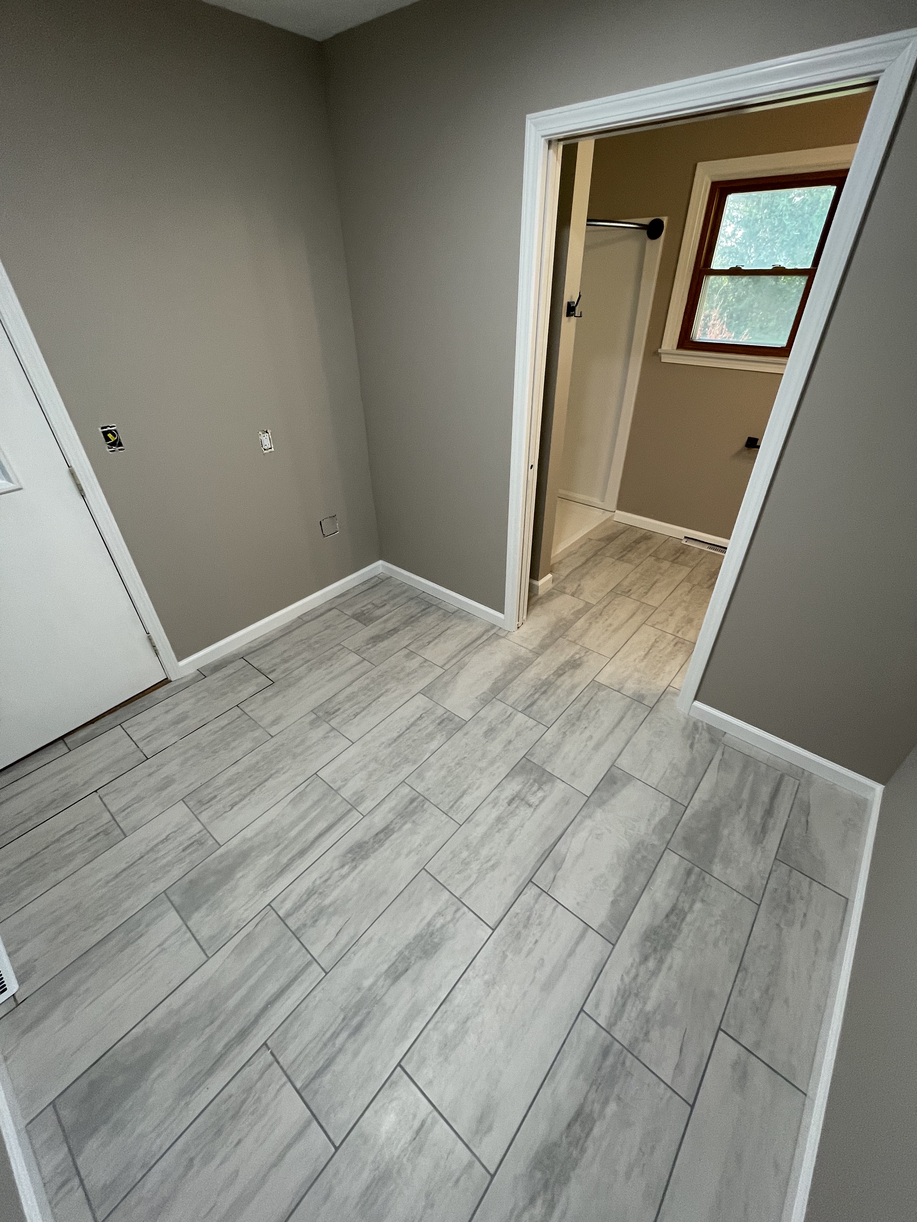 Gray tile floor at a bathroom entry