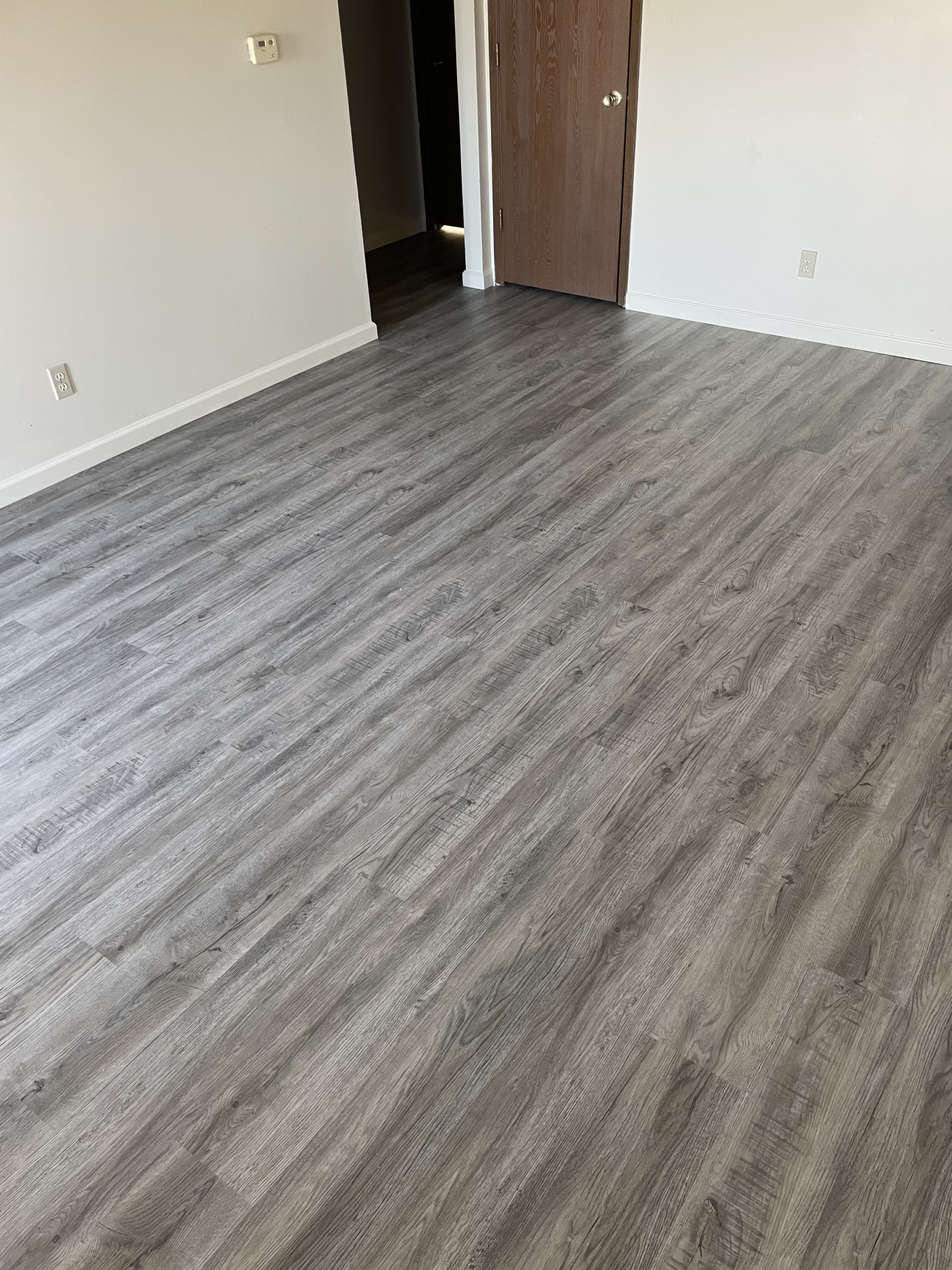 Room with gray wood-look flooring