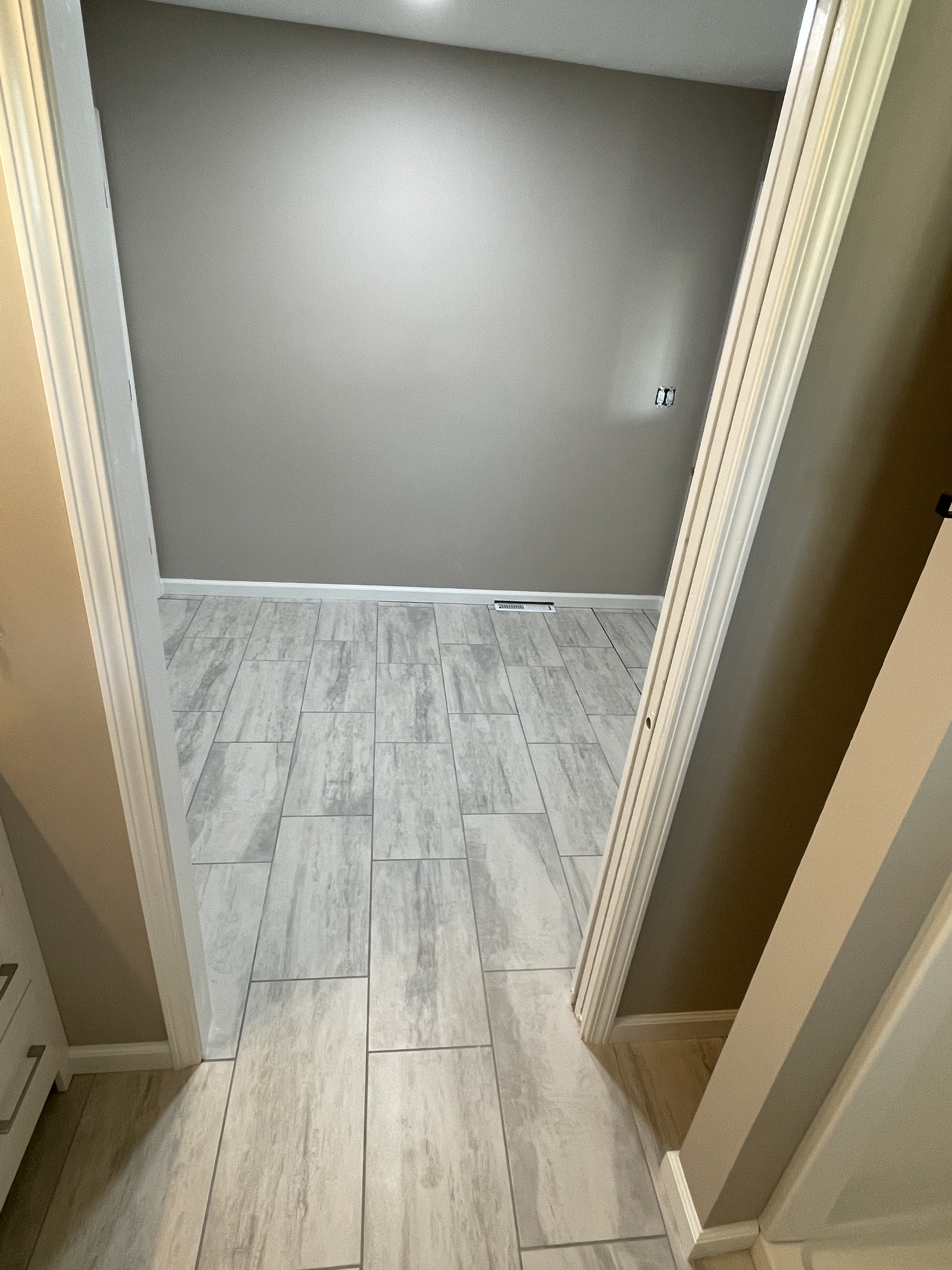 Gray tile floor in a hallway