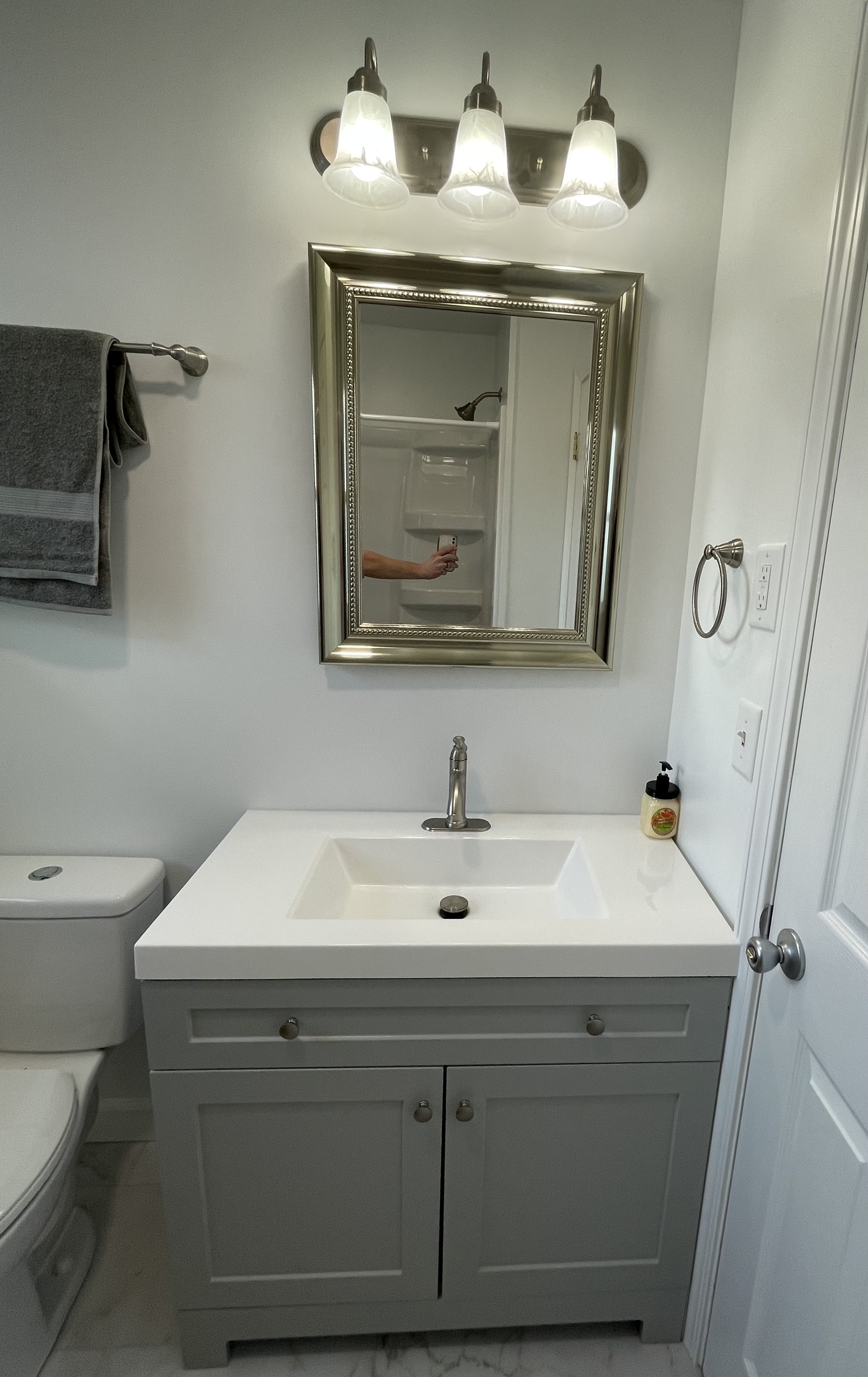 White bathroom vanity and mirror