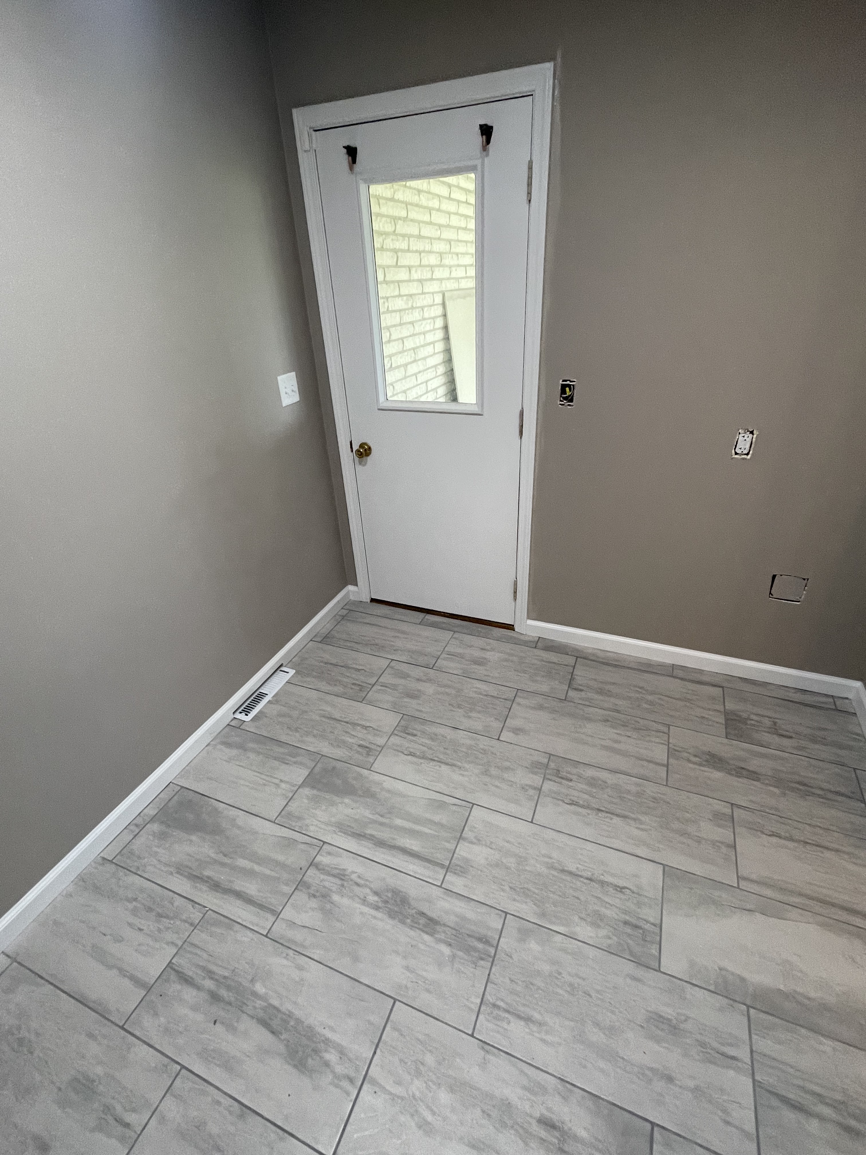Gray tile floor at an exterior door