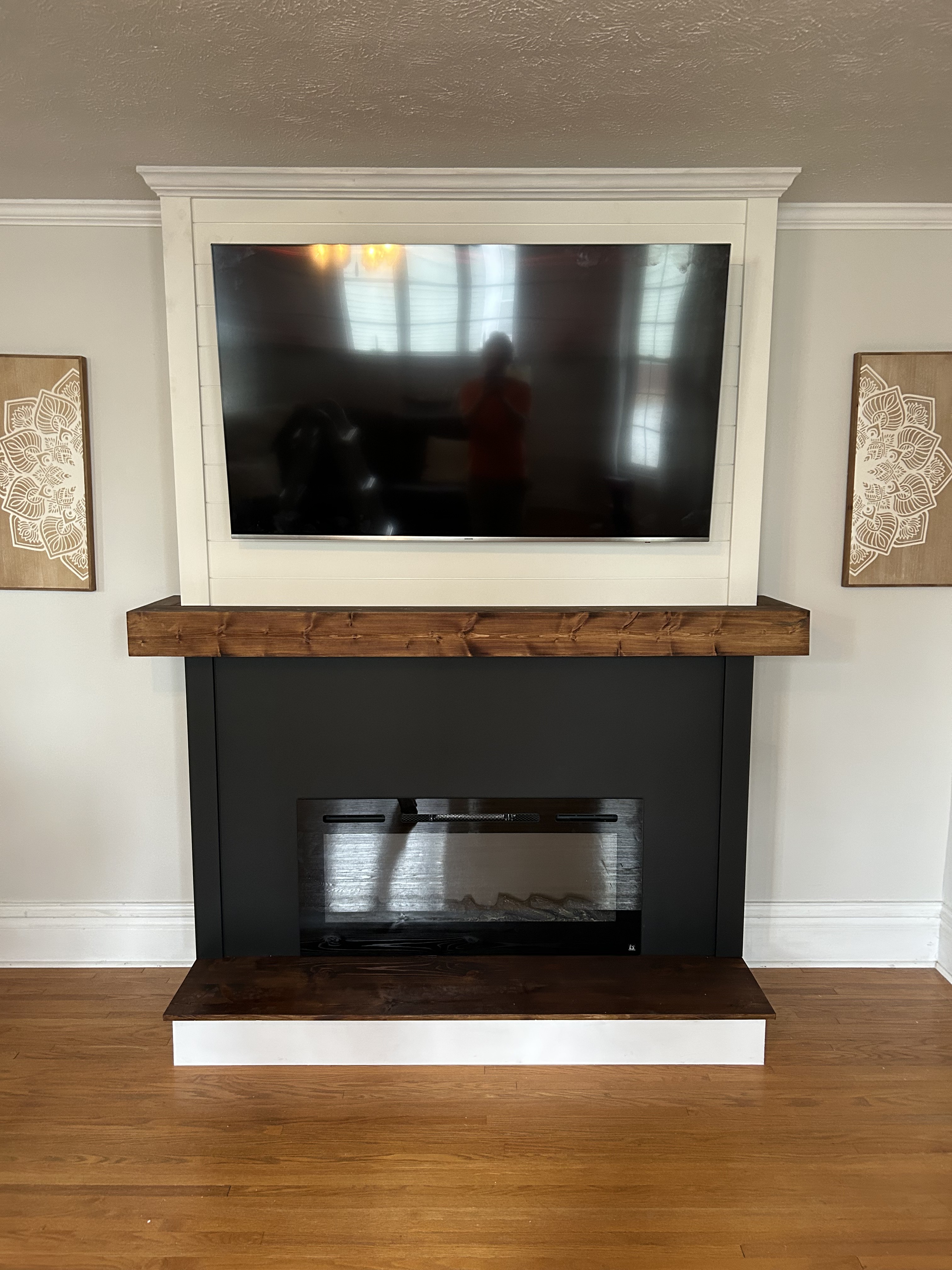 Fireplace remodel with a TV above the mantel