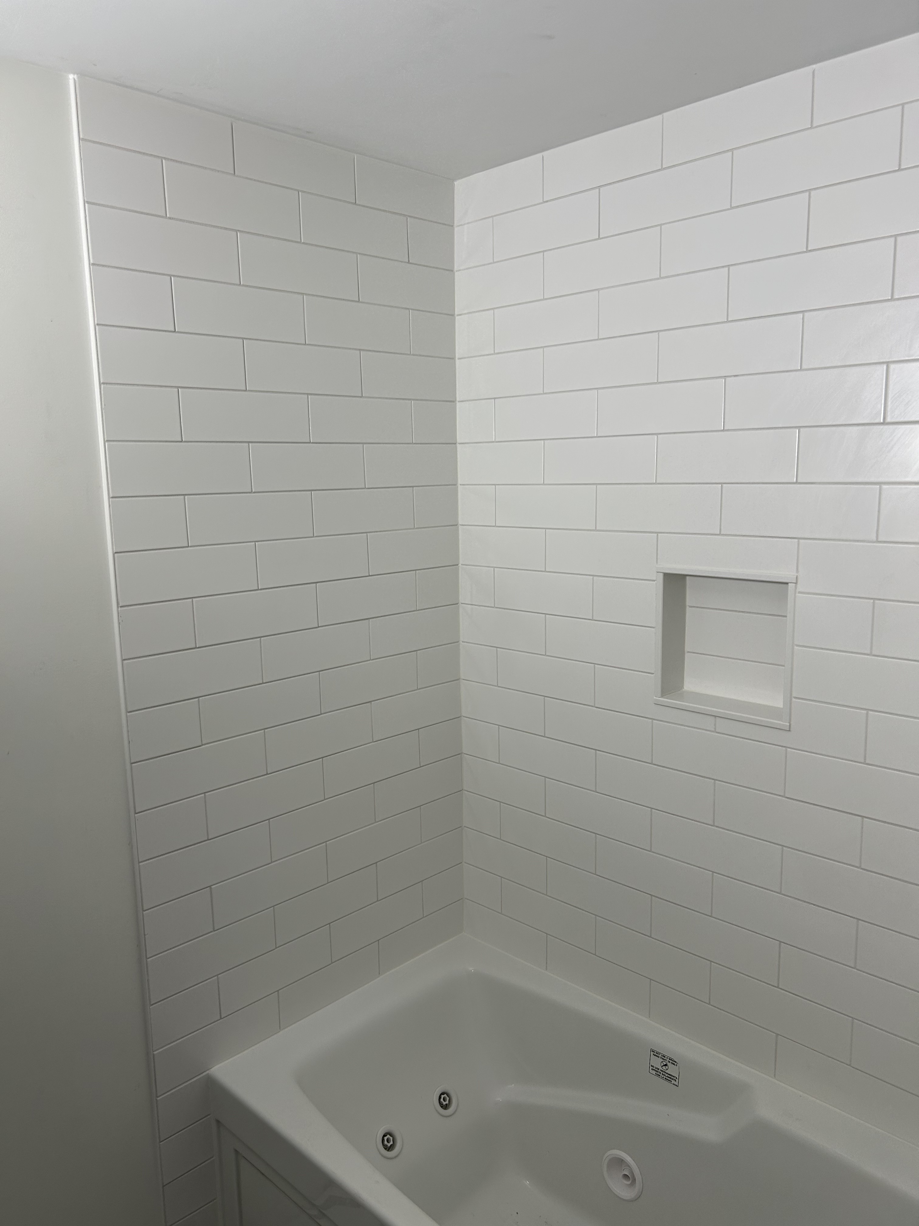 Tub with a finished tile surround