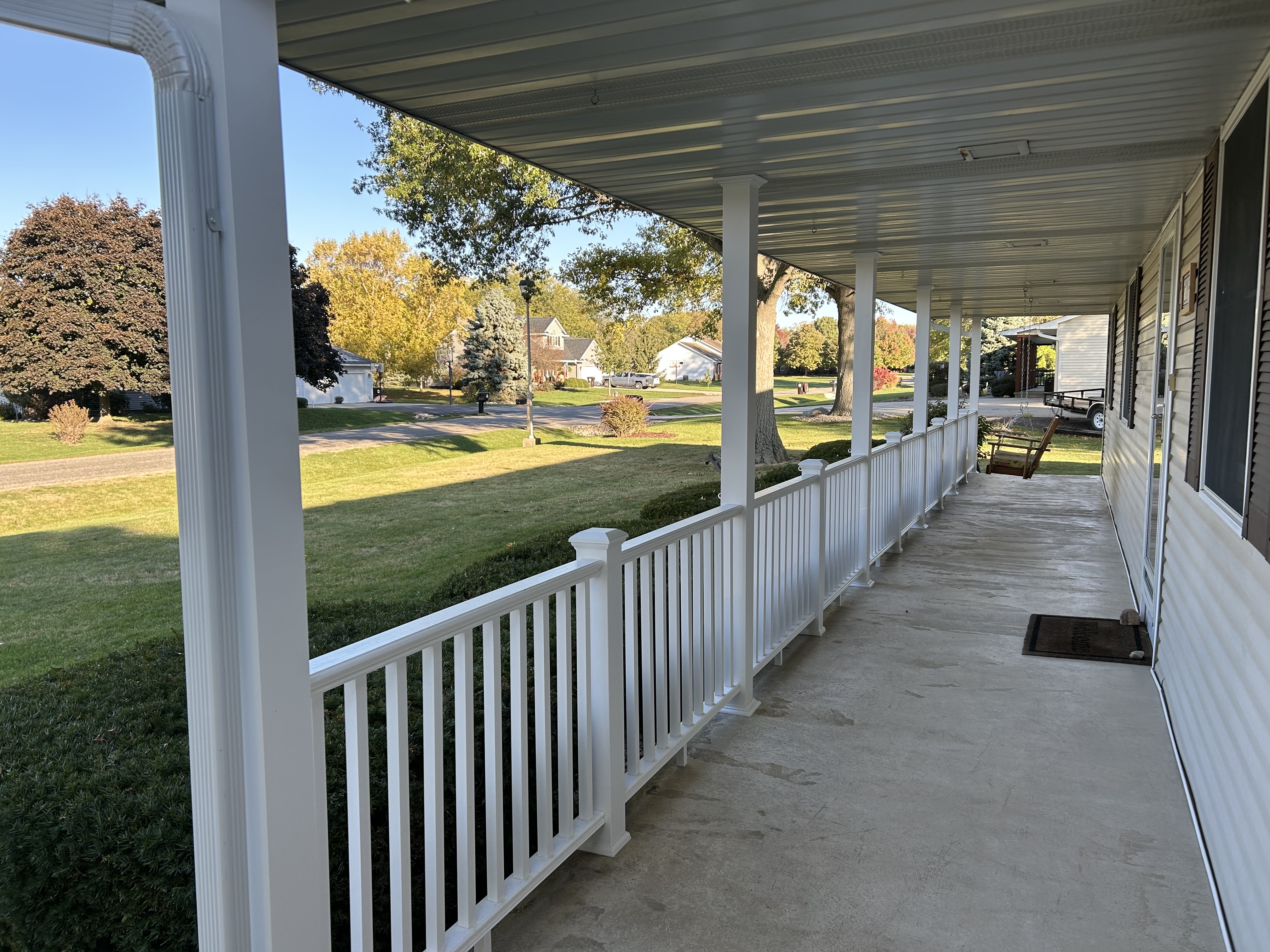 Covered porch with new white railing