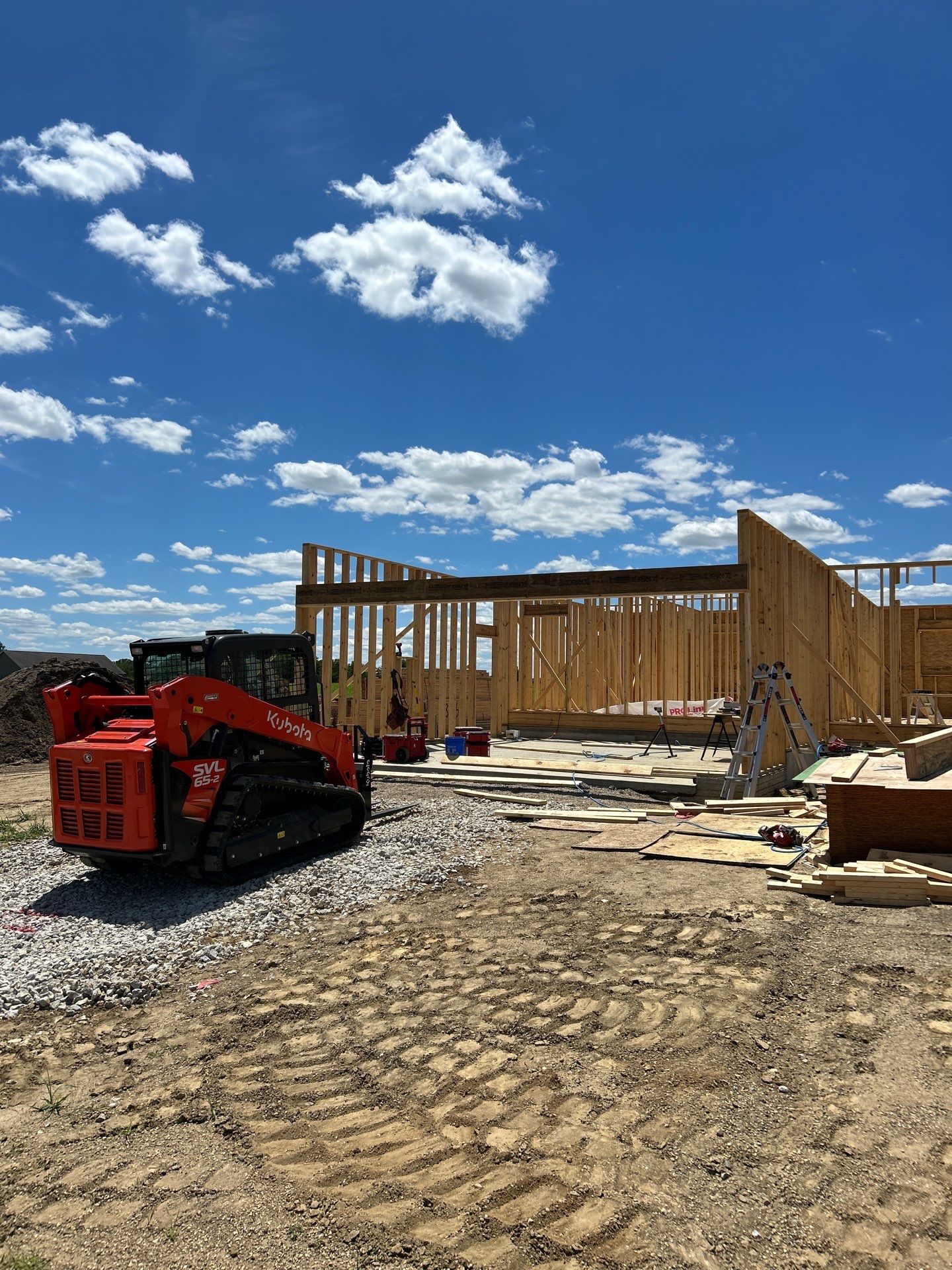 Framing and a skid steer on site (work in progress)