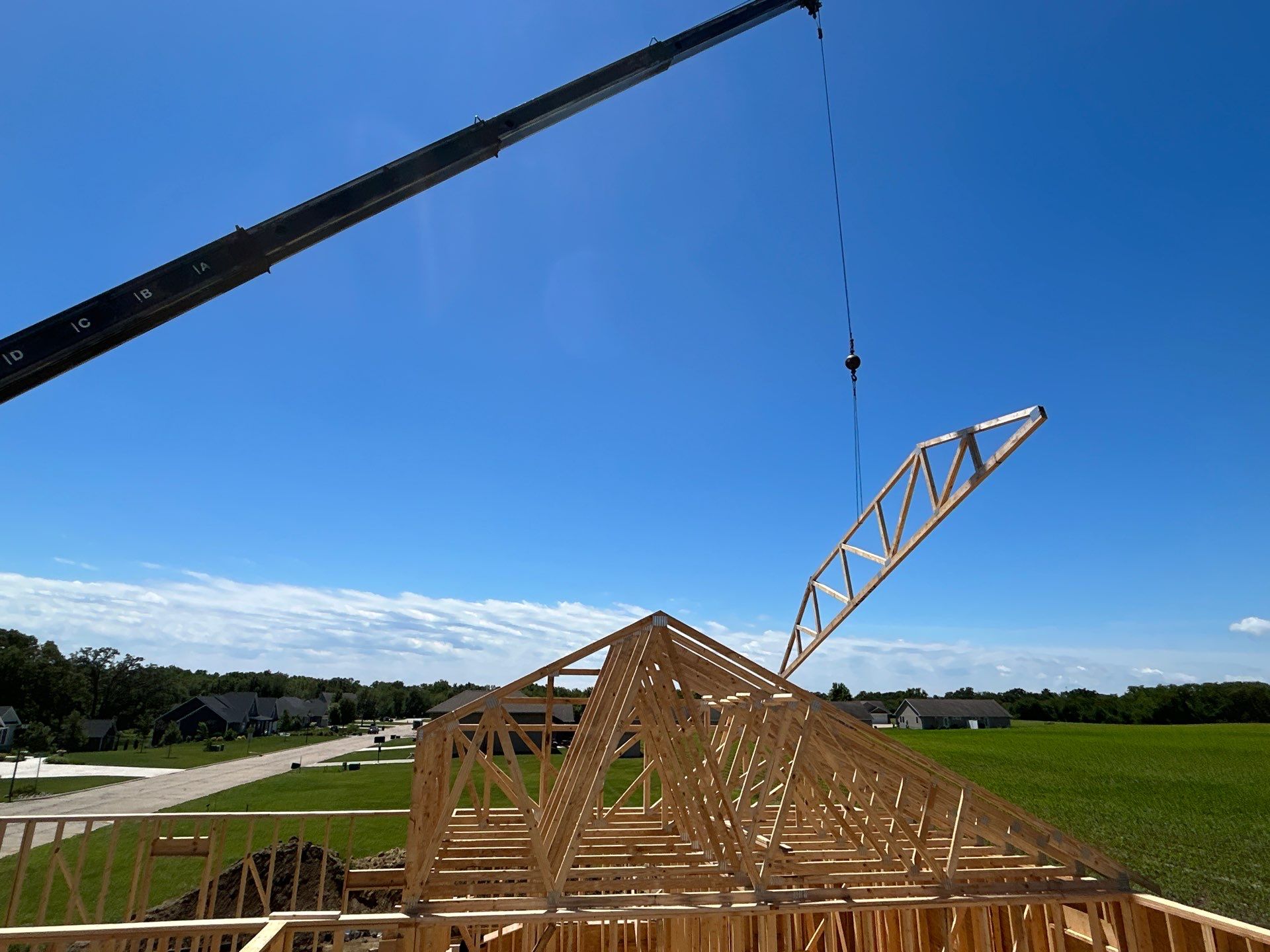 Crane setting roof trusses