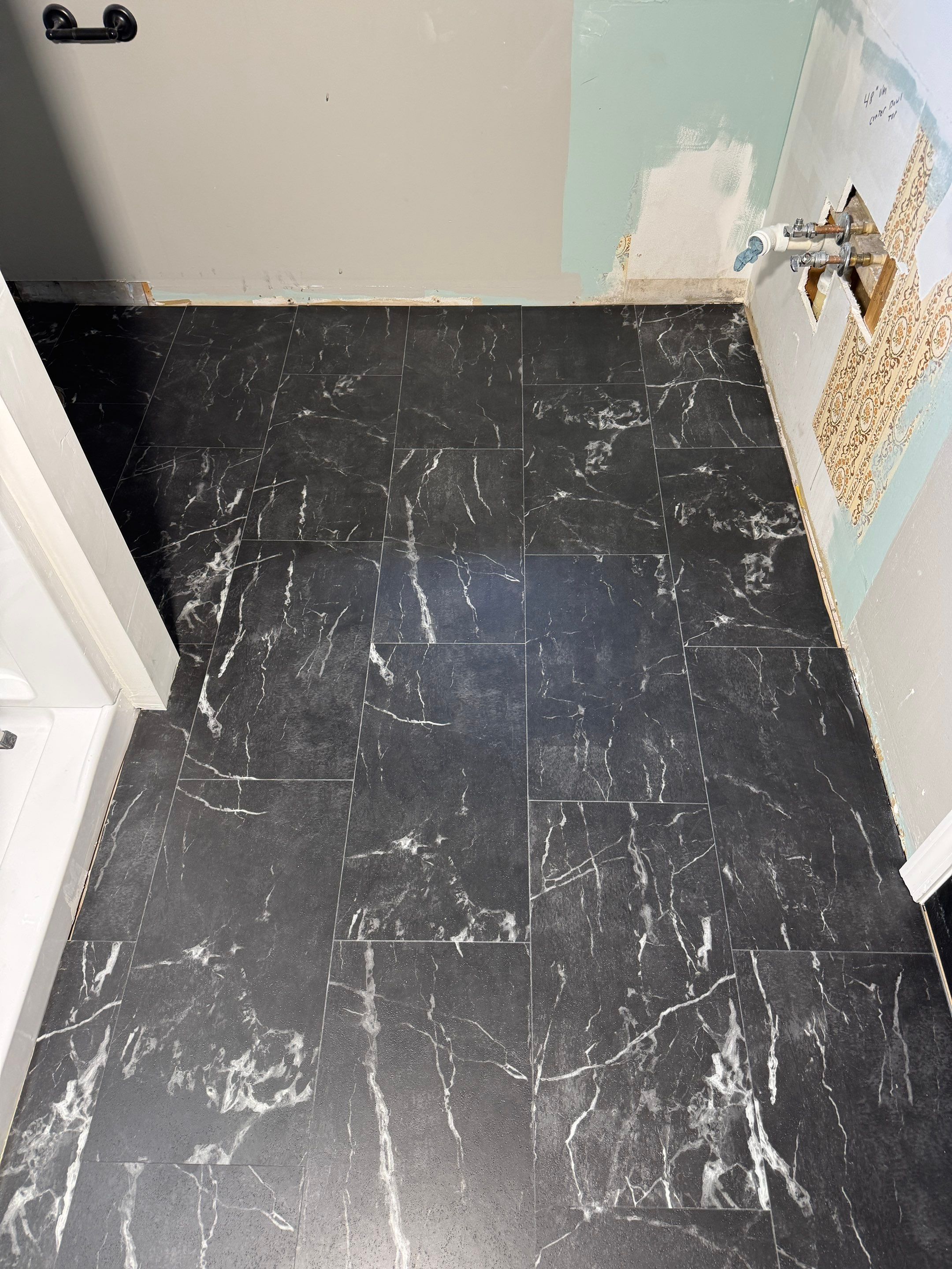 Black tile bathroom floor going in (work in progress)