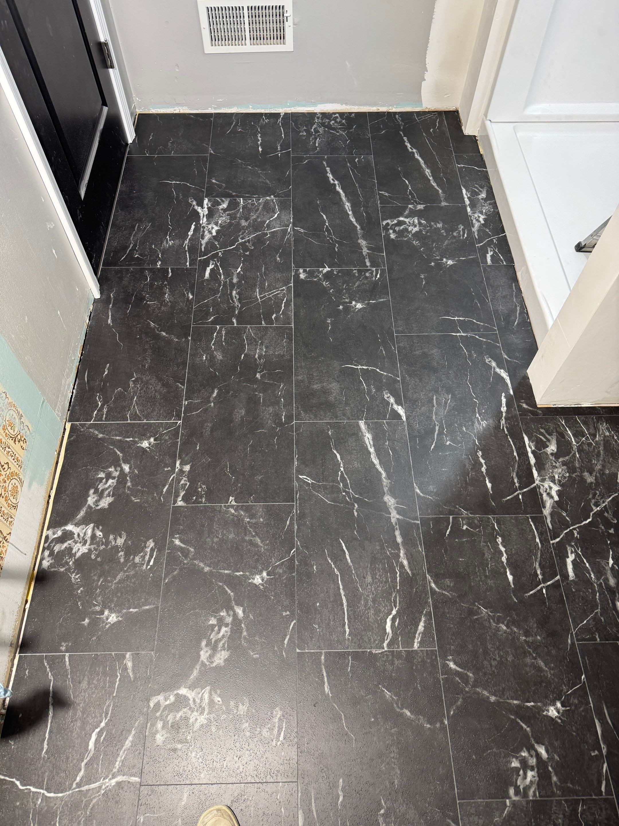 Black tile floor during installation (work in progress)