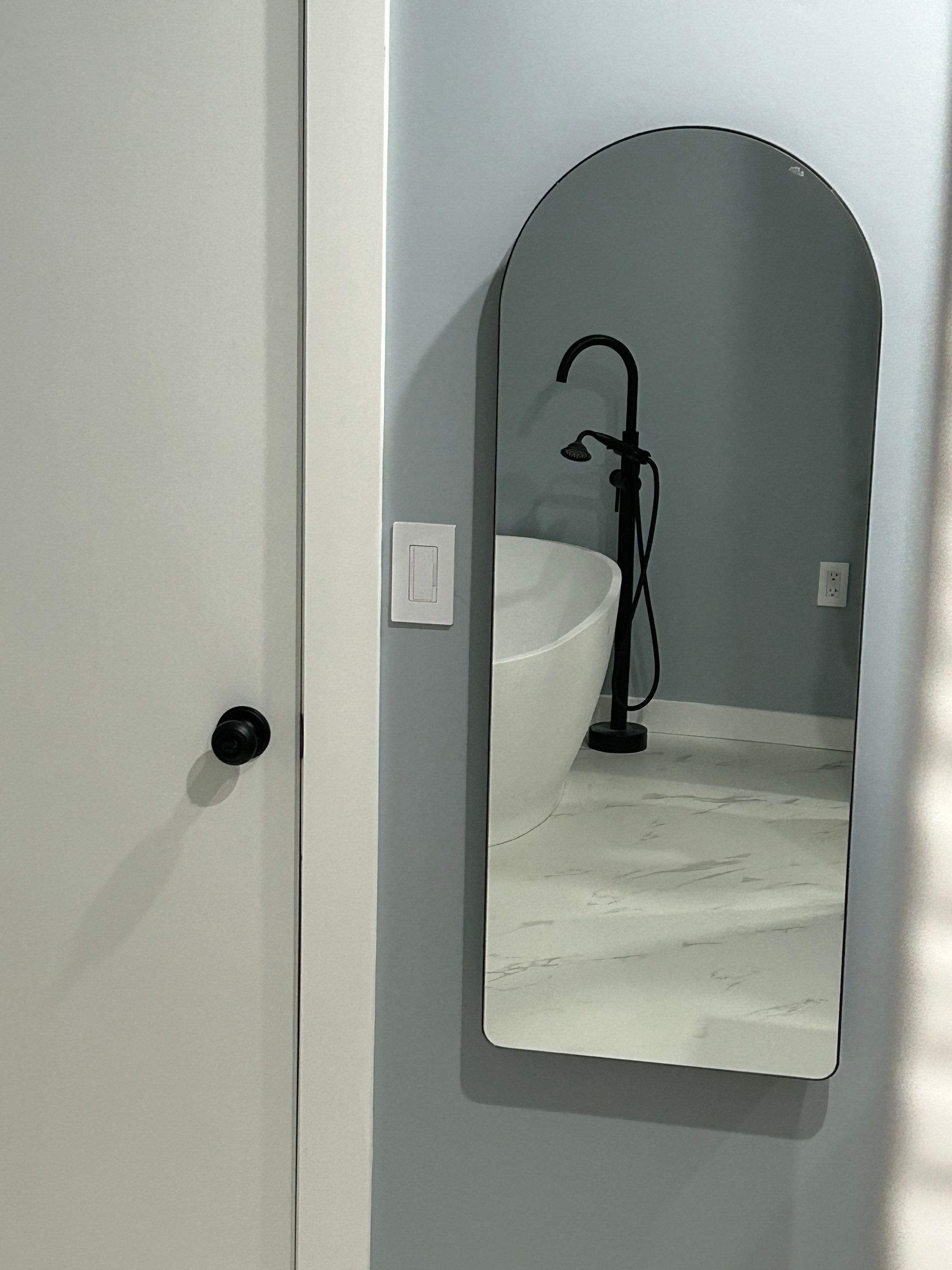 Bathroom with an arched entry