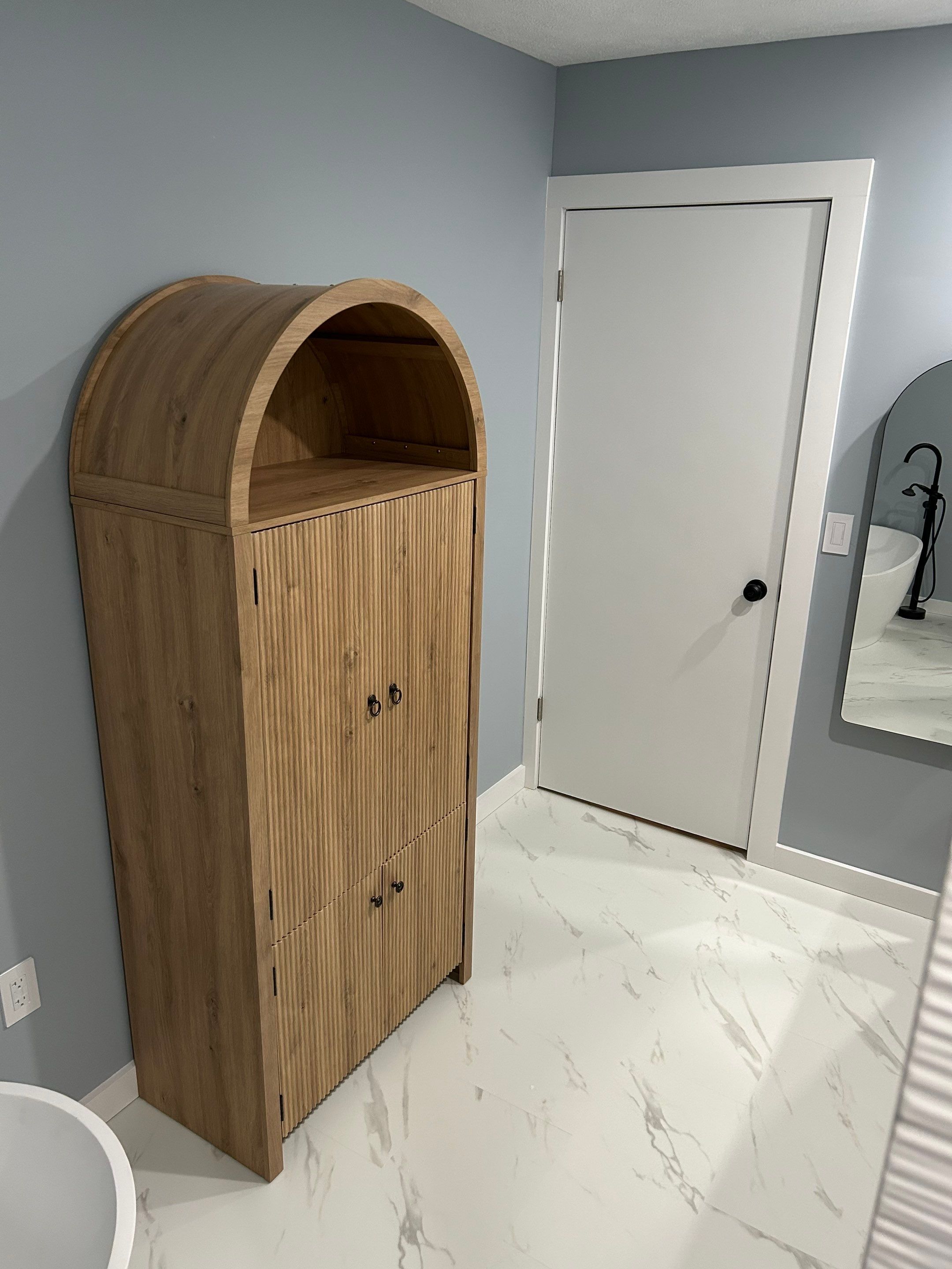 Arched entry and built-in cabinet