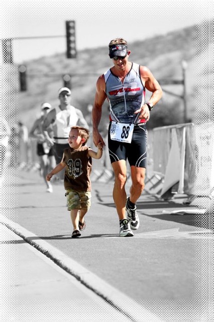 Dr. Andreas Boettcher crossing an Ironman finish line with his son