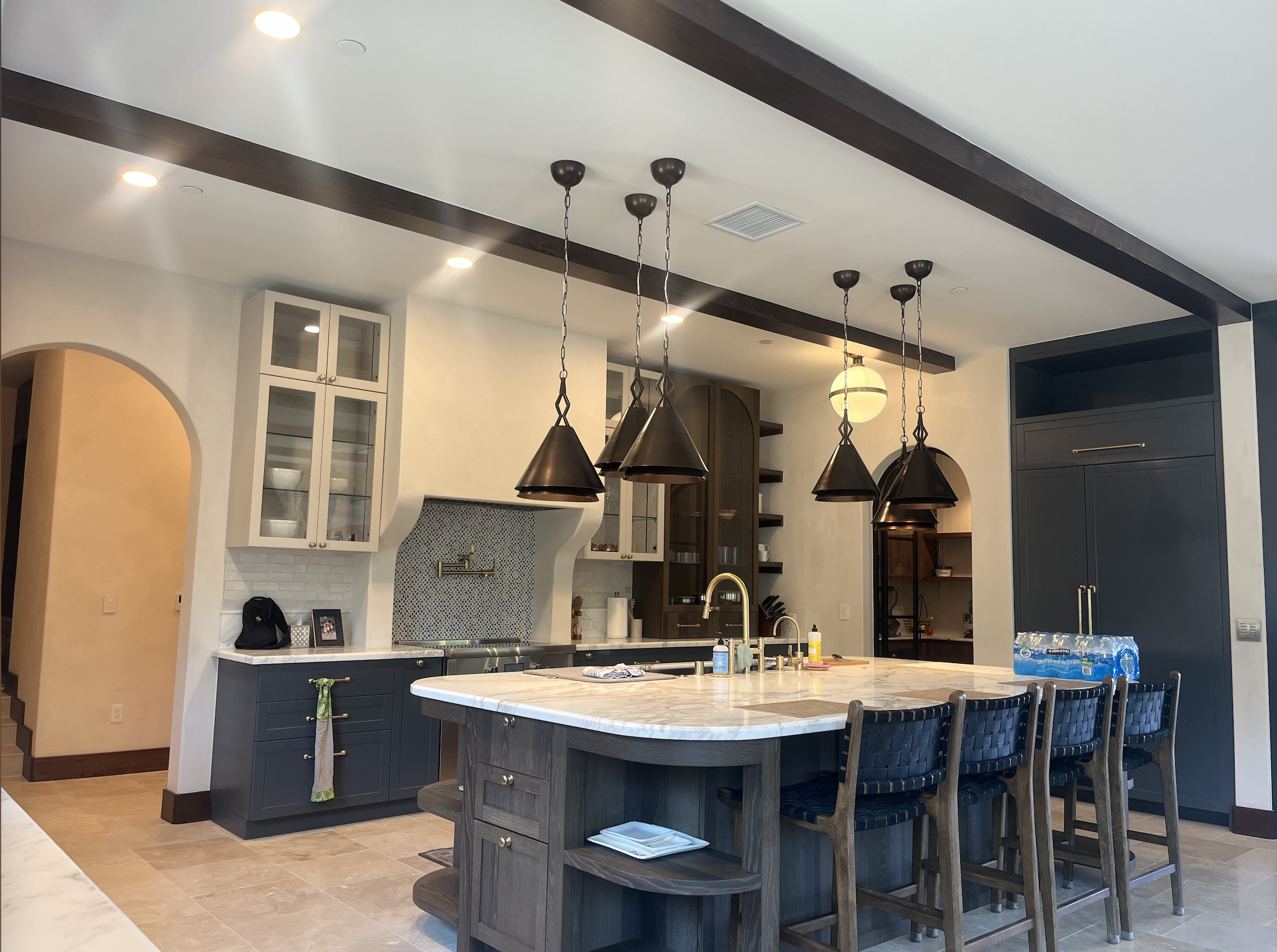 Custom kitchen with cone pendants and marble island