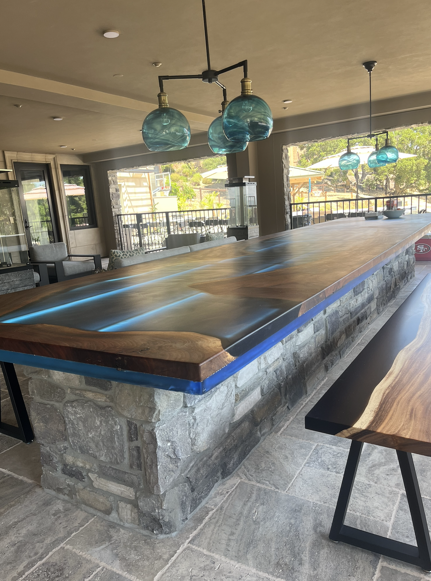 Outdoor live-edge bar with stone base