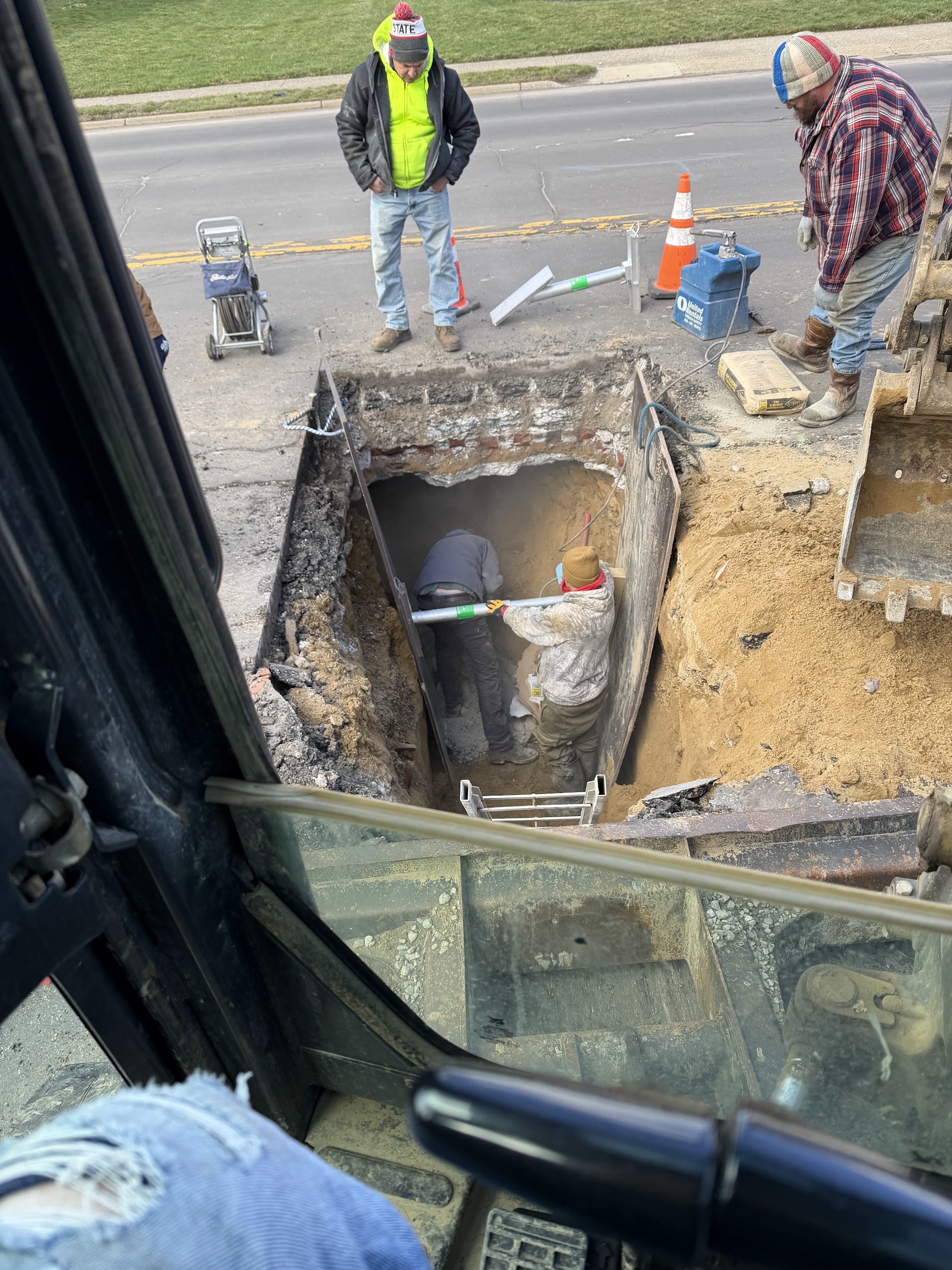 S&K heavy excavator machinery on outdoor sewer trenching project