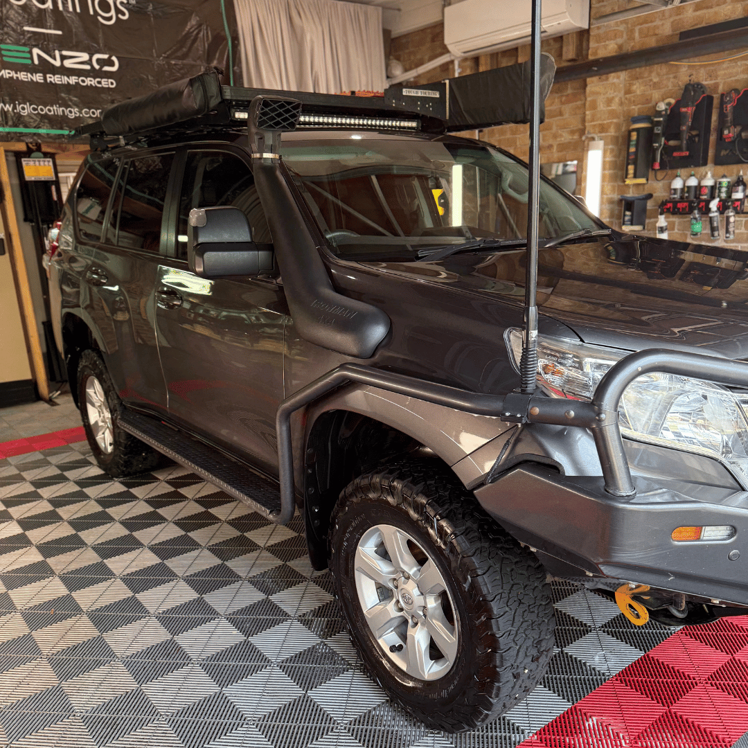 Grey truck parked in a detailing studio