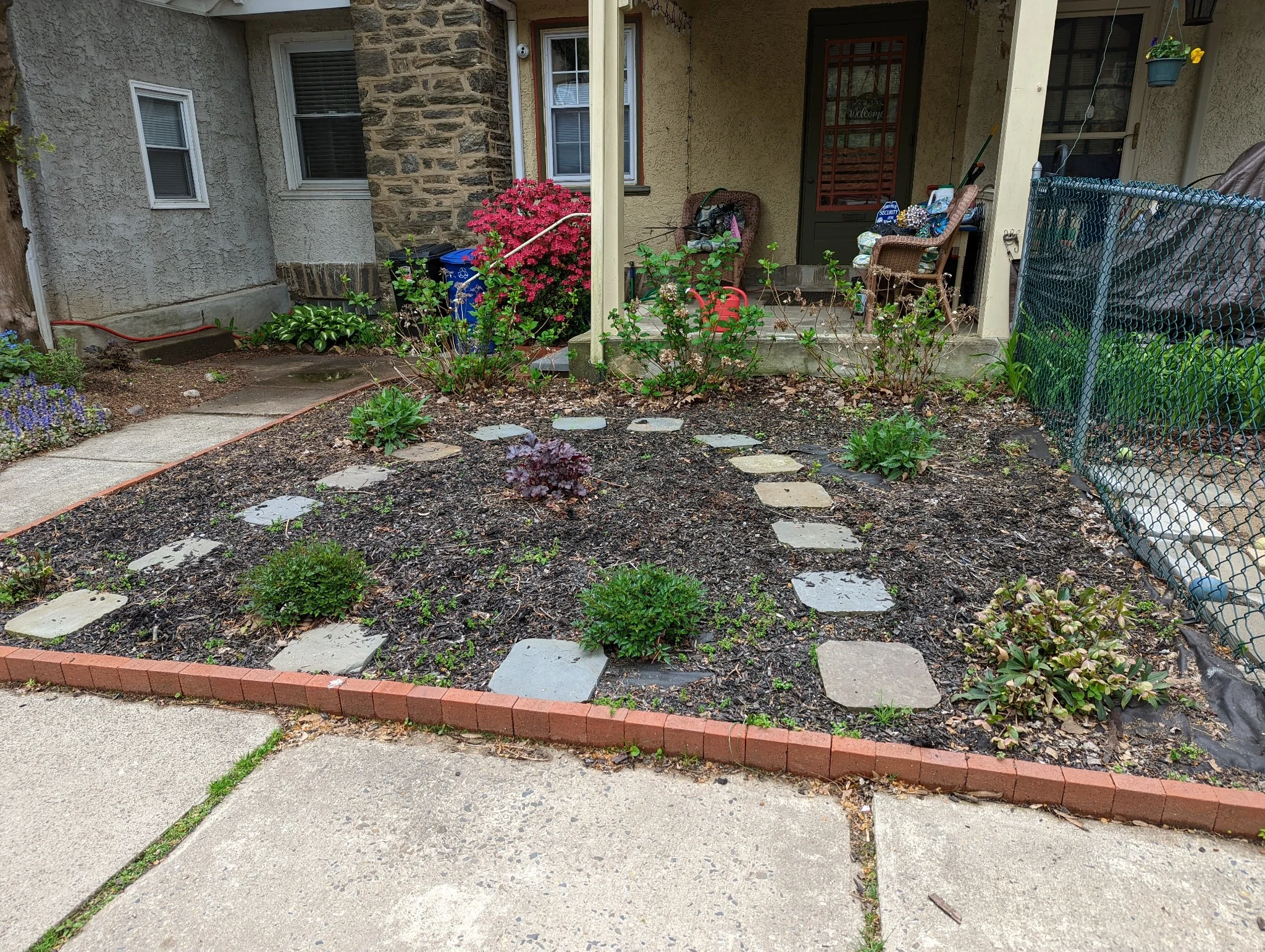 Freshly mulched garden bed along house