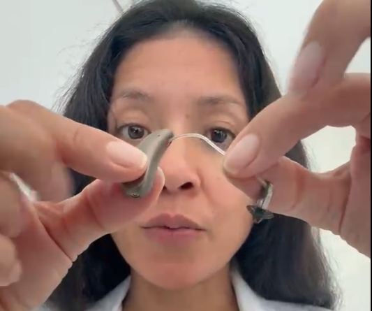 Locating where the receiver connector plugs into the bottom of the hearing aid body