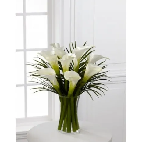 Arrangement of White Calla Lilies and Palm Leaves