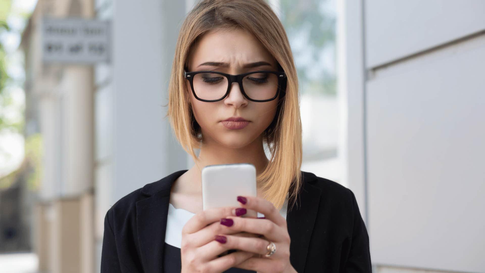 A woman struggling to write a social media post